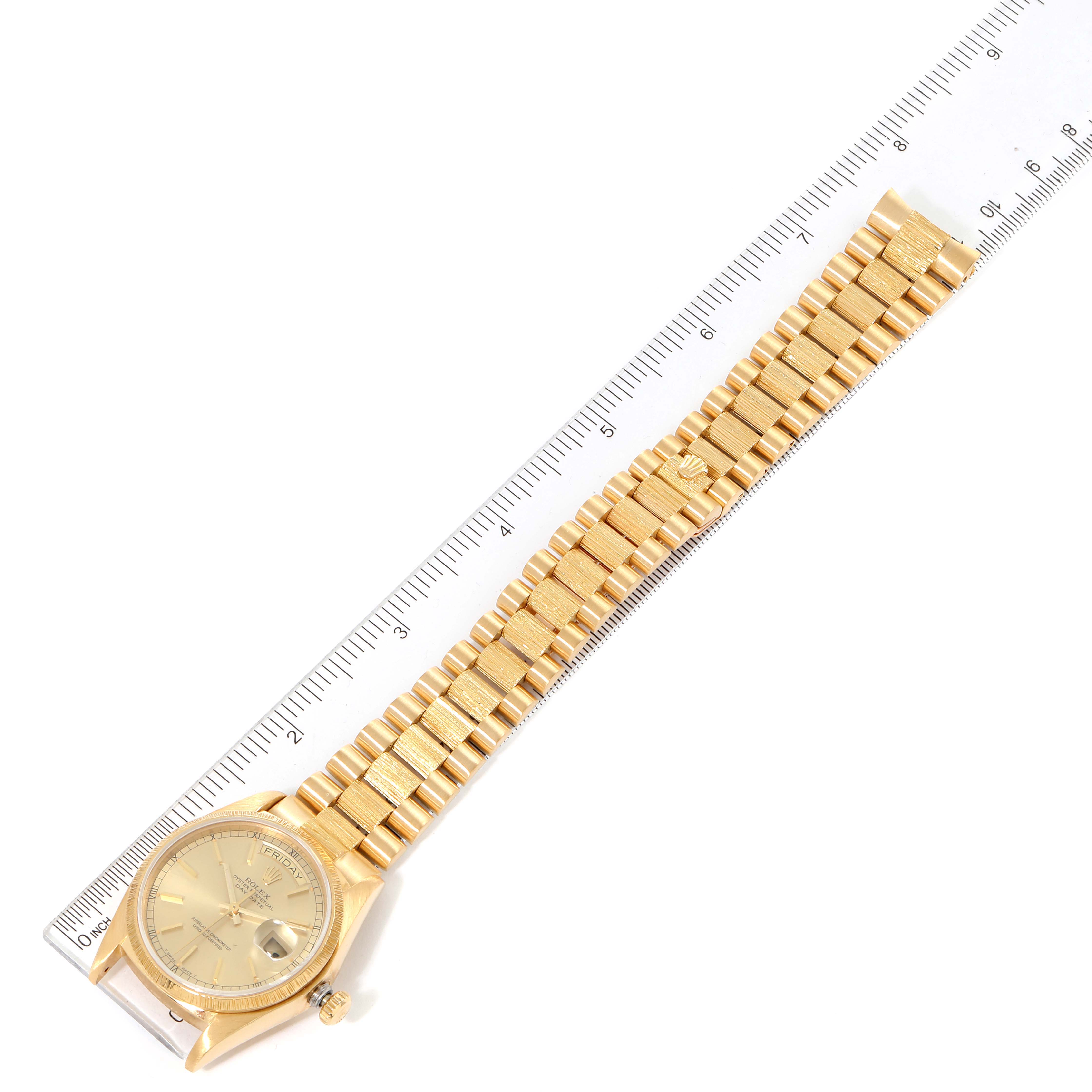 The image shows a gold Rolex President 18078 Men
s Yellow Gold Champagne Dial 18078 Men
s Yellow Gold Champagne Dial watch laid flat with a ruler beside it.