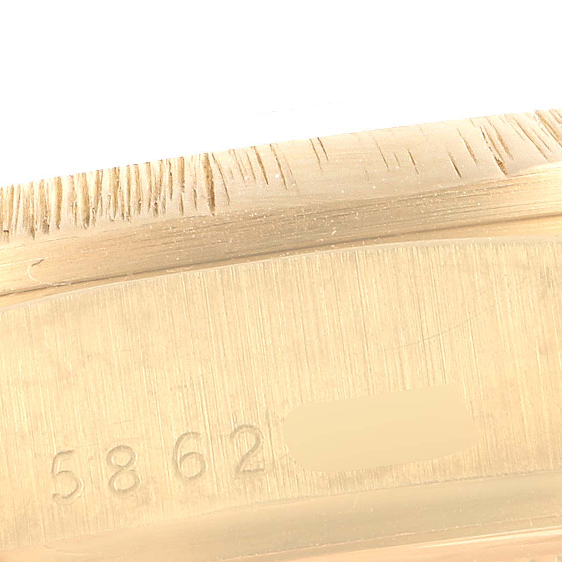 This close-up image shows the engraved serial and model numbers on the interior of a Rolex President 18078 Men
s Yellow Gold Champagne Dial 18078 Men
s Yellow Gold Champagne Dial watch case.