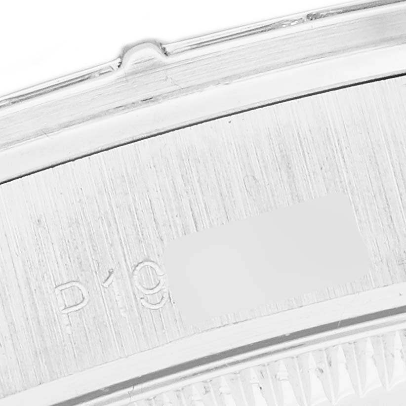 This image shows a close-up of the case back edge with engraved serial numbers of the Rolex President 78266 Women
s Platinum Blue Dial 78266 Women
s Platinum Blue Dial model watch.