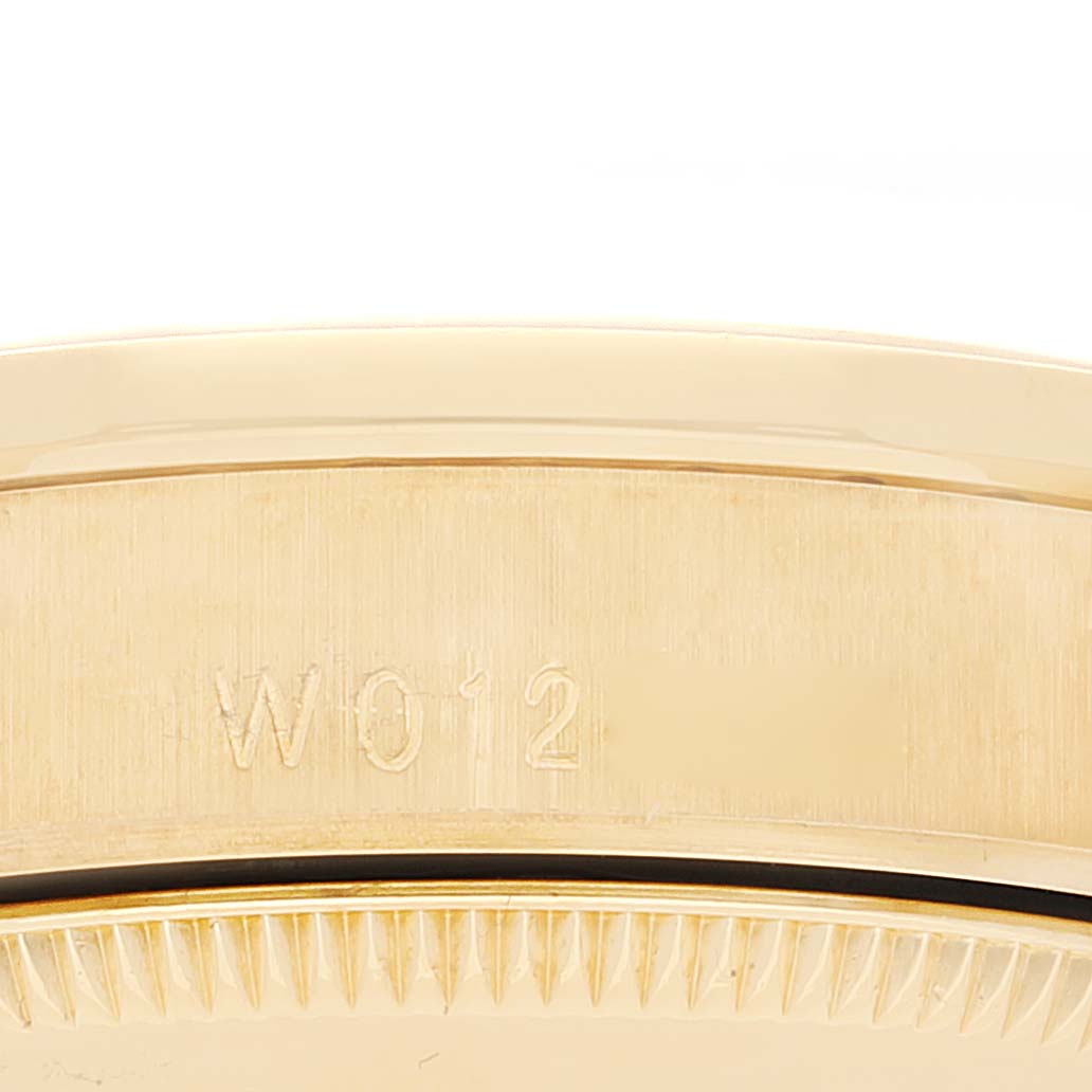 The image shows a close-up of the side of a Rolex President 68158 Women
s Yellow Gold Champagne Dial 68158 Women
s Yellow Gold Champagne Dial model, highlighting the serial number engraving.