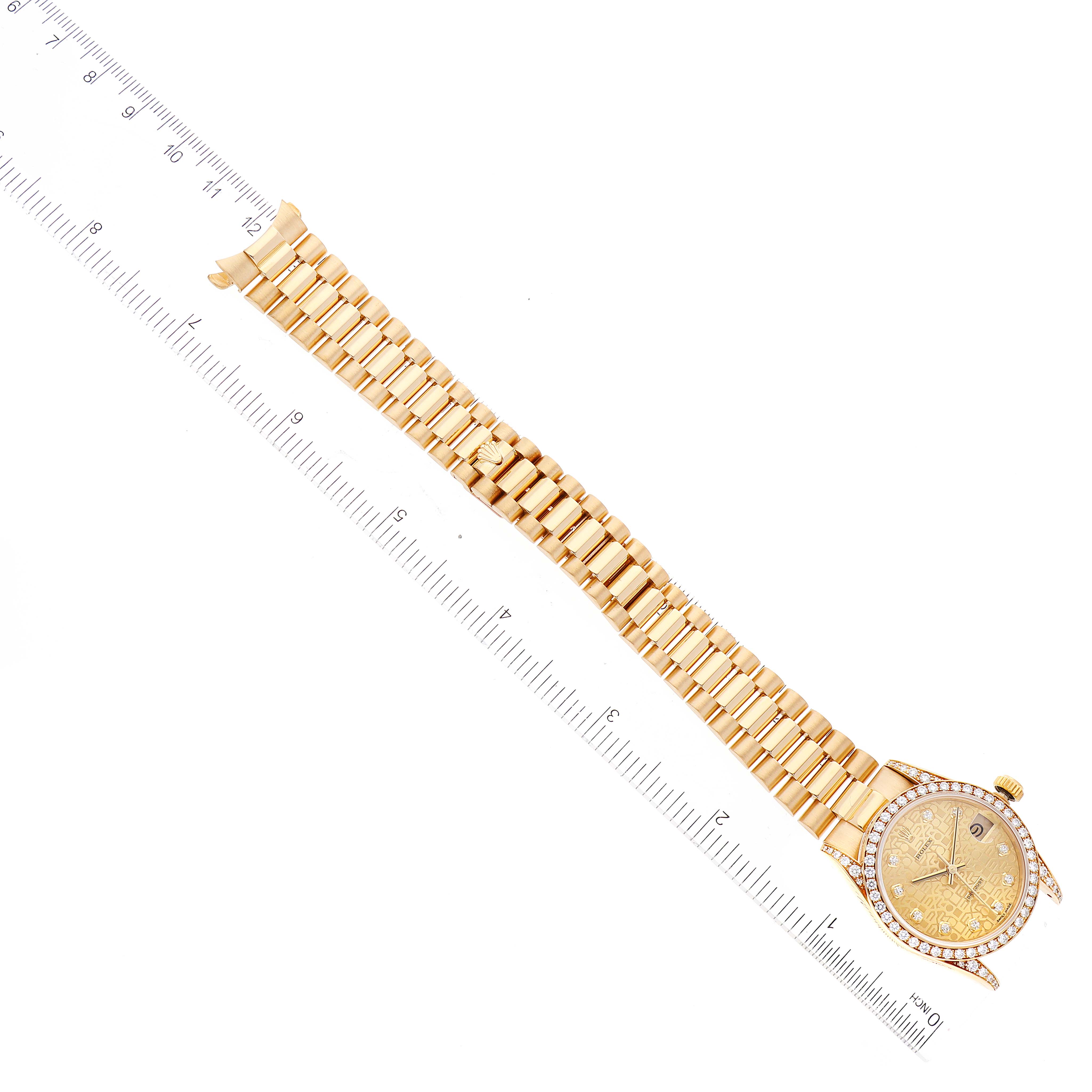 The image shows a gold Rolex President 68158 Women
s Yellow Gold Champagne Dial 68158 Women
s Yellow Gold Champagne Dial watch with a diamond-accented bezel and bracelet, laid next to a ruler for scale.