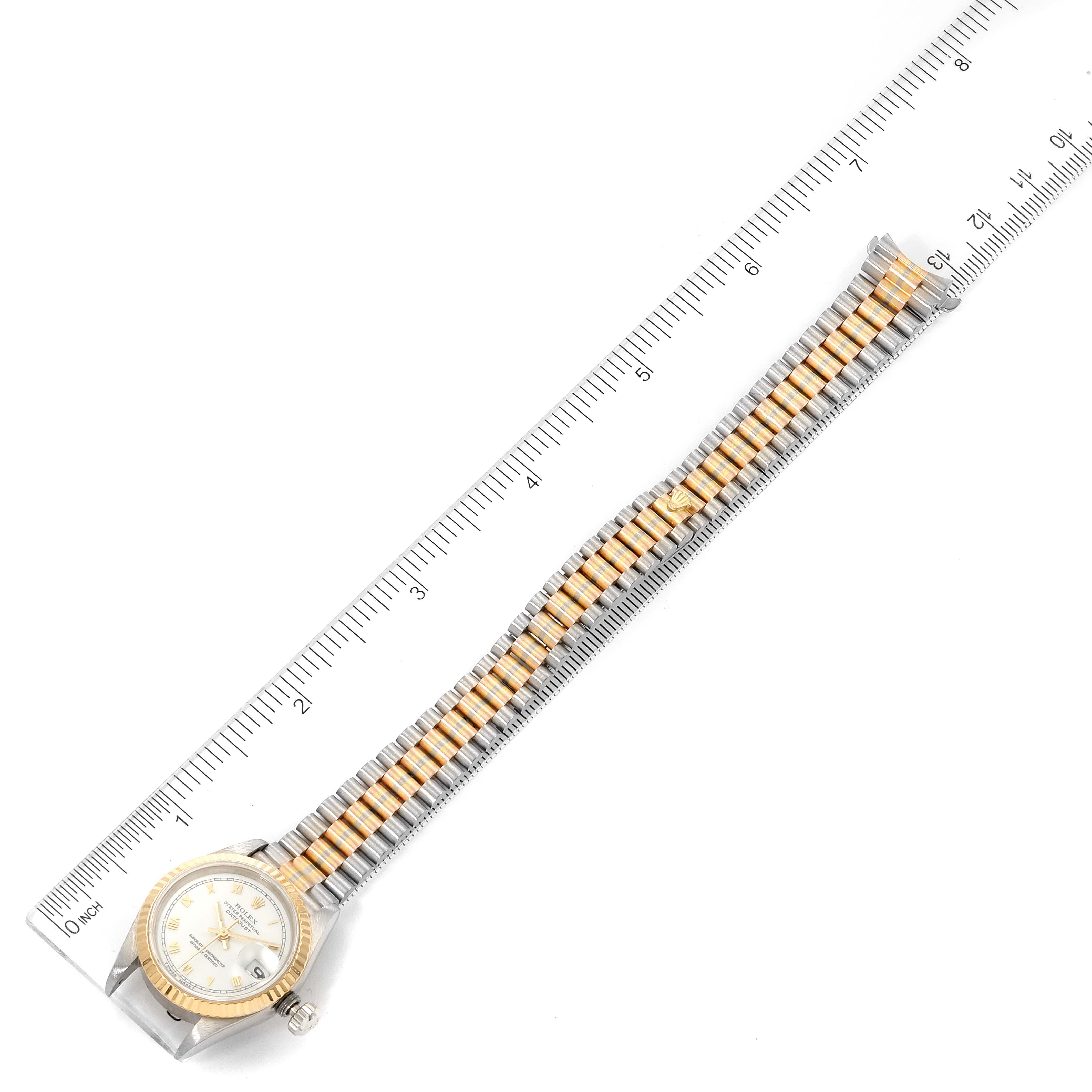 The image shows a Rolex President 69179 Women's White Gold White Dial 69179 Women's White Gold White Dial watch from a top-down angle, fully displaying the watch face and entire bracelet against a ruler.