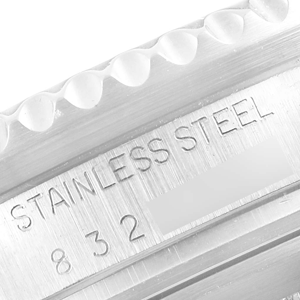 The image shows a close-up of the stainless steel bezel and casing of a Vintage Collection Rolex watch.