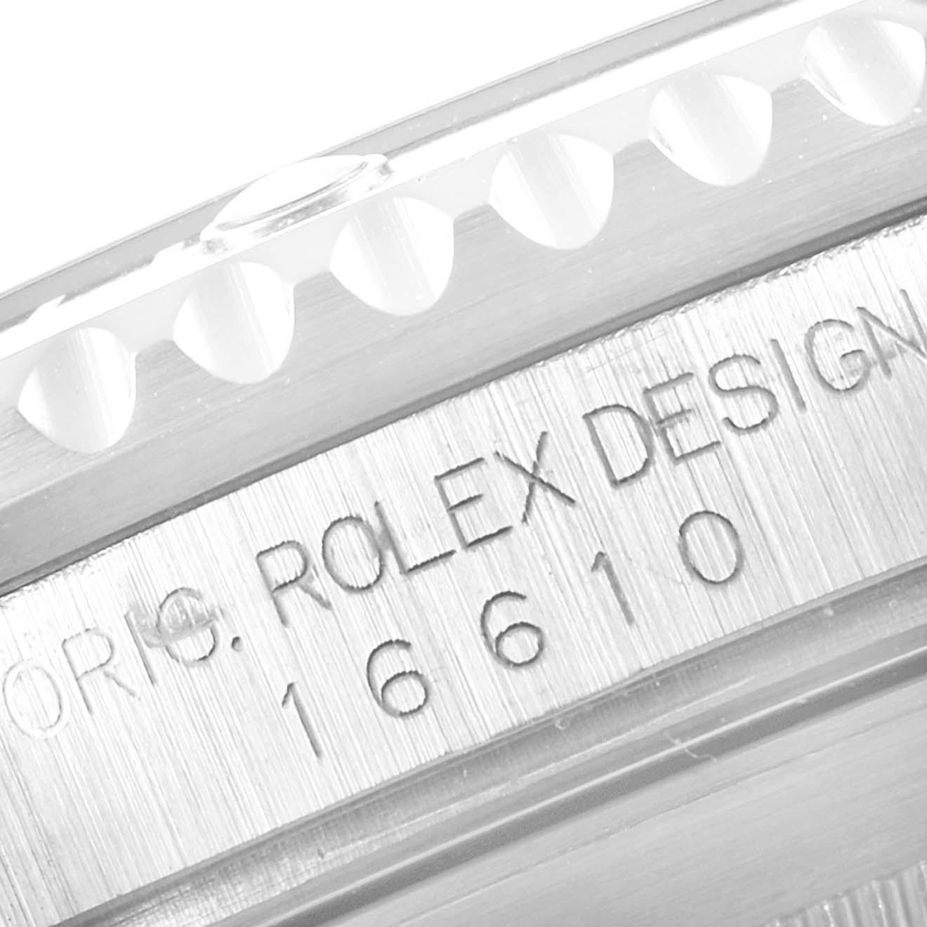 The image shows a close-up of the engraved bezel and case of a Rolex Submariner 16610 Men
s Stainless Steel Black Dial 16610 Men
s Stainless Steel Black Dial model 16610.