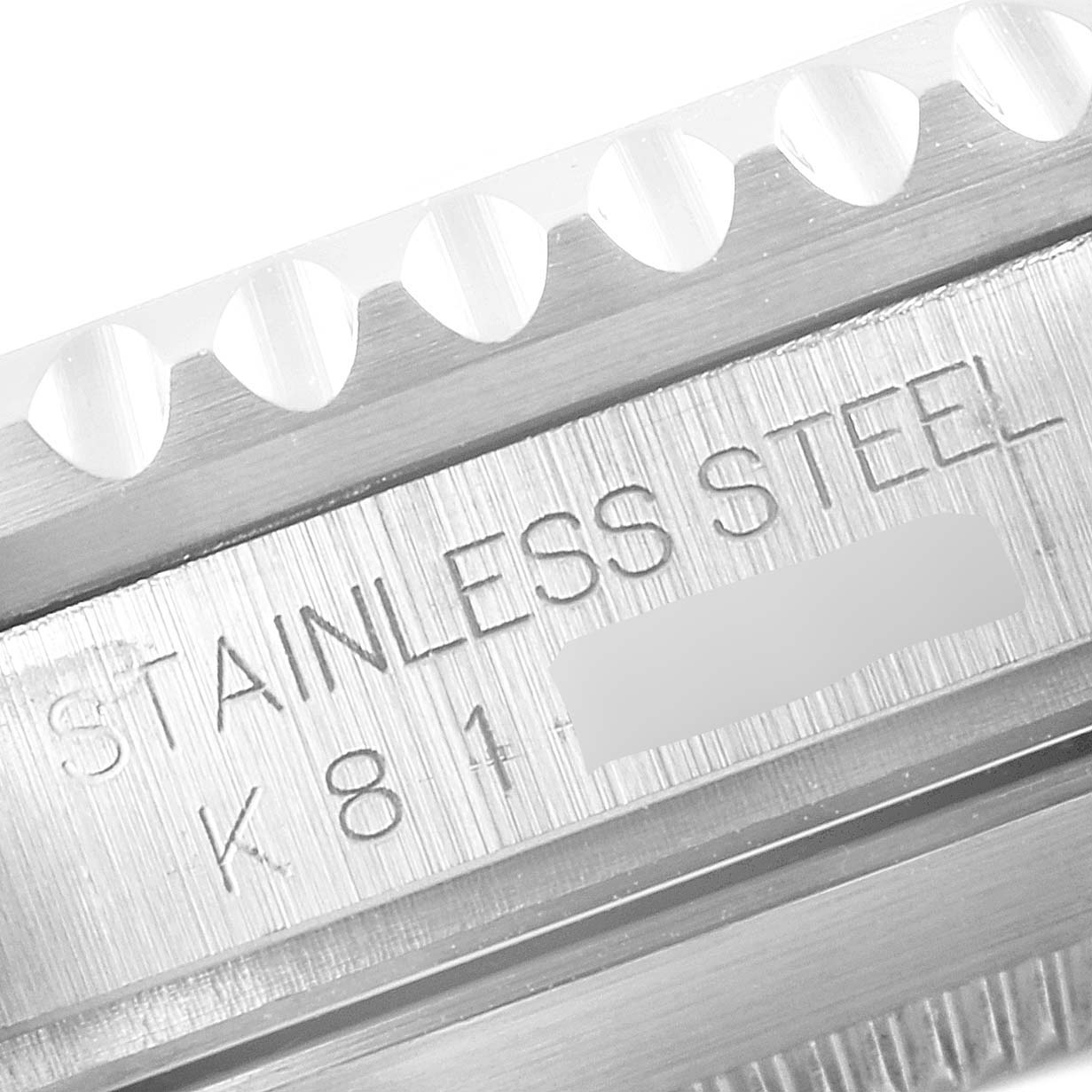 This image shows a close-up of the case engraving and part of the bezel on the Rolex Submariner 16610 Men
s Stainless Steel Black Dial 16610 Men
s Stainless Steel Black Dial watch, indicating "STAINLESS STEEL".