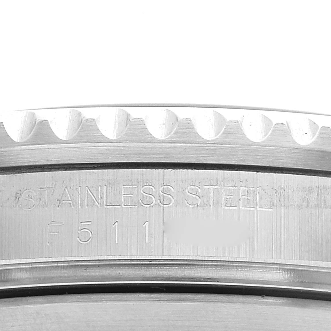 This close-up image shows the case side of the Rolex Submariner 16610 Men
s Stainless Steel Black Dial 16610 Men
s Stainless Steel Black Dial, highlighting the stainless steel engraving and part of the bezel.