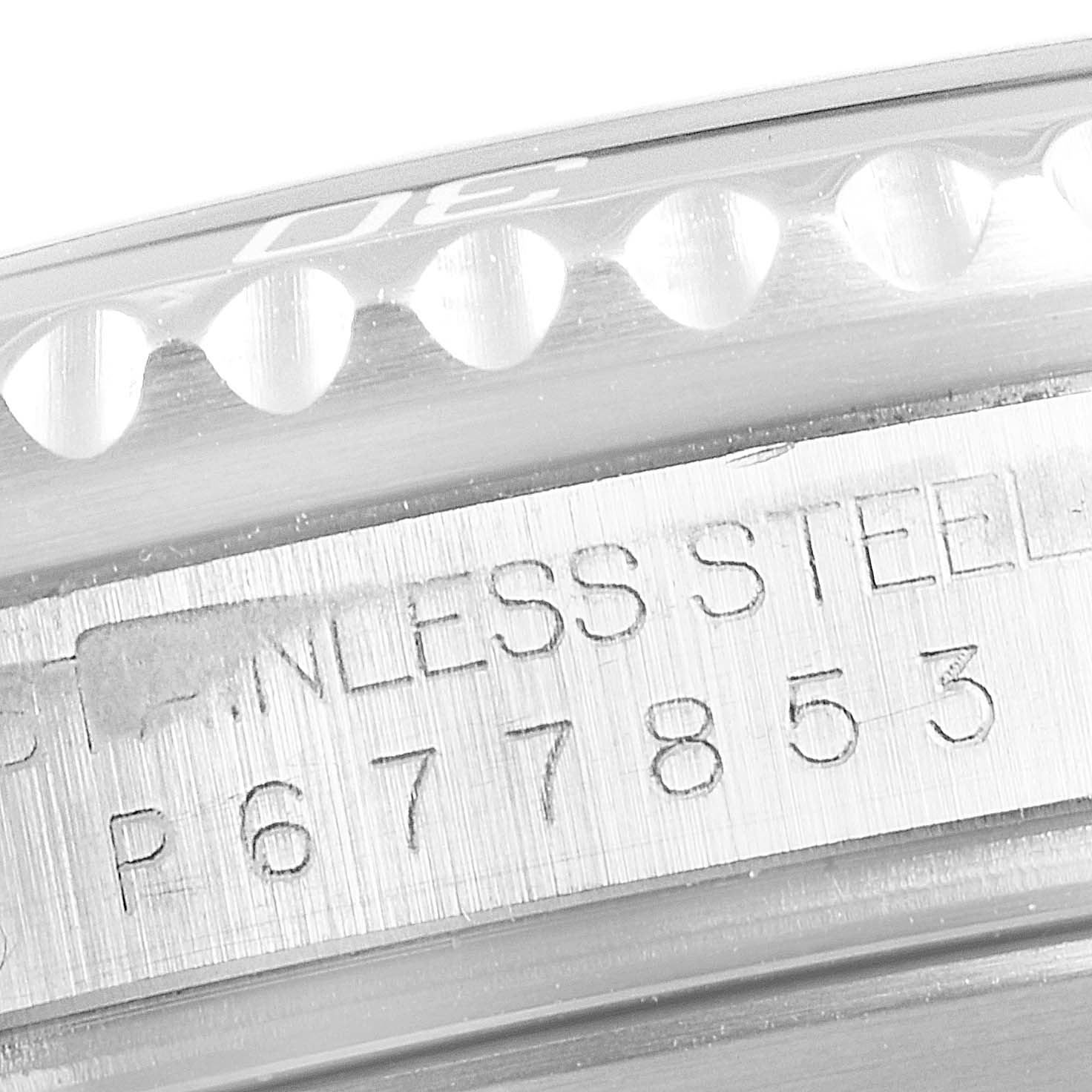 This image shows a close-up of the bezel and engraving on the stainless steel case of a Rolex Submariner 16610 Men
s Stainless Steel Black Dial 16610 Men
s Stainless Steel Black Dial watch.