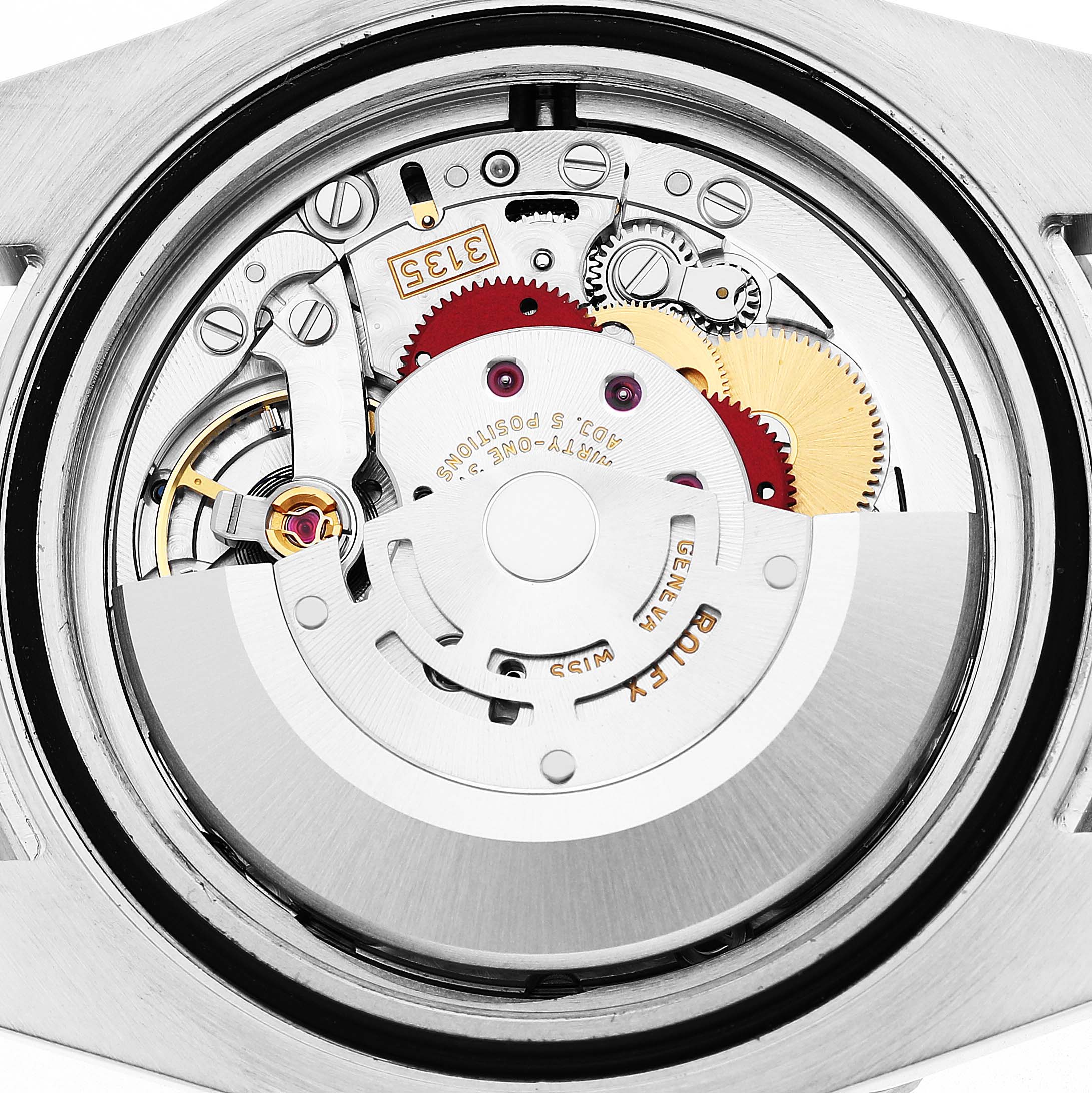 The image shows the open case back view of the Rolex Submariner 116610LV Men's Stainless Steel Green Dial, highlighting its movement and intricate gears.