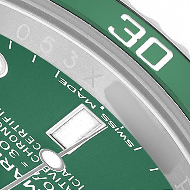The image shows a close-up of the green dial and bezel of a Rolex Submariner 116610LV Men's Stainless Steel Green Dial, including the minute markers and part of the hands.