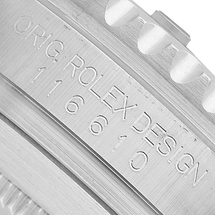 The image shows a close-up of the case side of a Rolex Submariner 116610LV Men's Stainless Steel Green Dial, displaying the model number and design engraving.