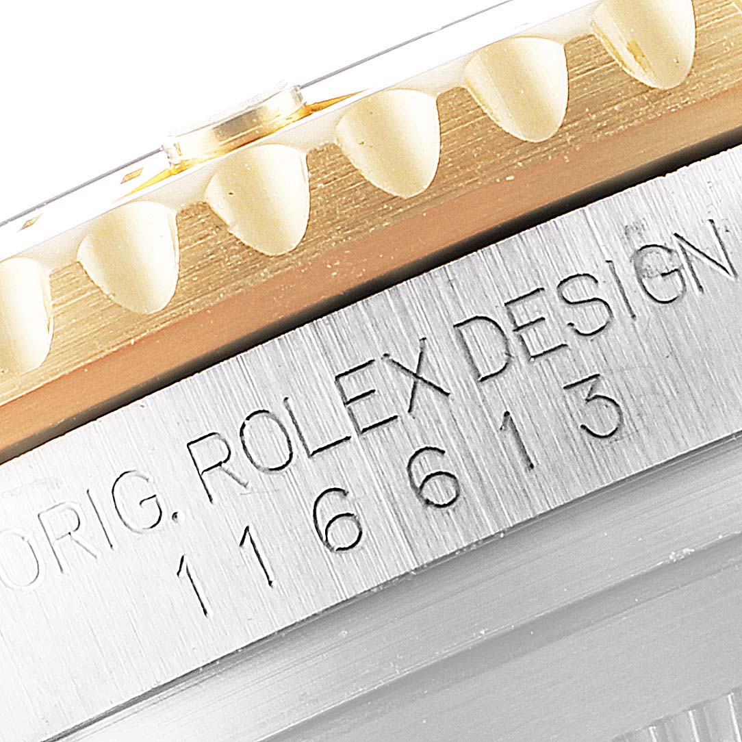 The image shows a close-up of the bezel and engraving on the side of a Rolex Submariner 116613 Men
s Steel and Gold (two tone) Blue Dial 116613 Men
s Steel and Gold (two tone) Blue Dial watch.