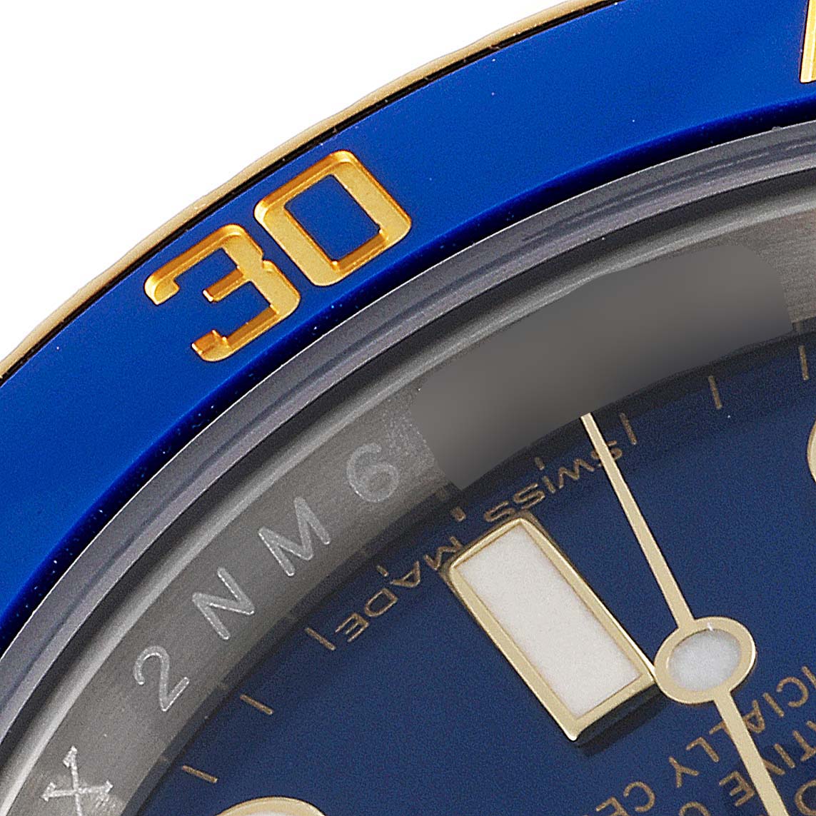This close-up image shows a partial view of the dial and bezel of a Rolex Submariner 116613 Men
s Steel and Gold (two tone) Blue Dial 116613 Men
s Steel and Gold (two tone) Blue Dial watch.