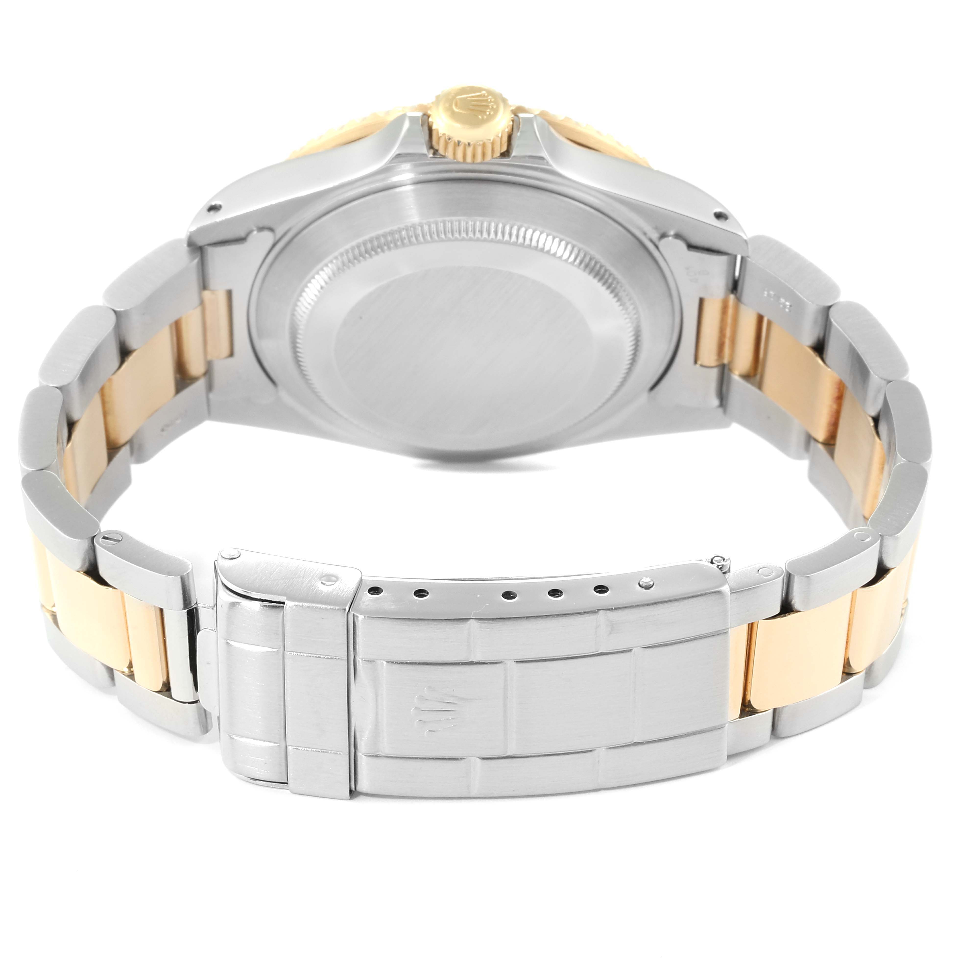 The image shows the back view of a Rolex Submariner 16613 Men
s Steel and Gold (two tone) Champagne Dial 16613 Men
s Steel and Gold (two tone) Champagne Dial watch, including its case back, crown, and two-tone bracelet with clasp.