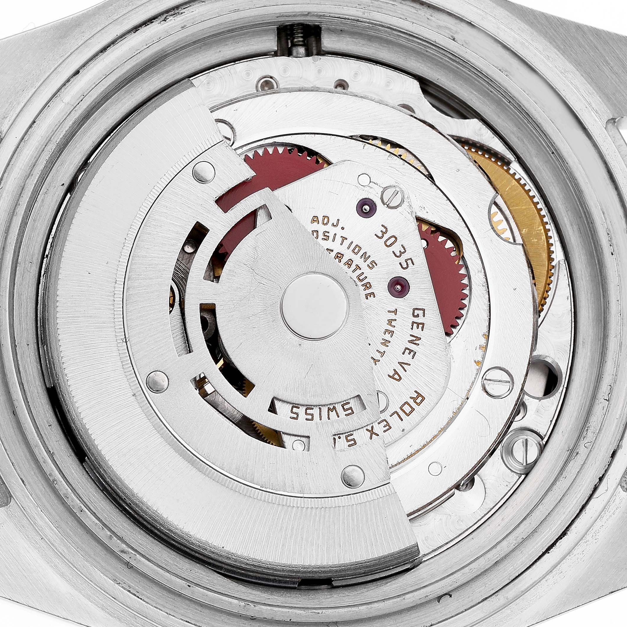 The image shows the intricate movement mechanism of a Rolex Submariner 16803 Men's Steel and Gold (two tone) Black Dial watch from a top-down angle.