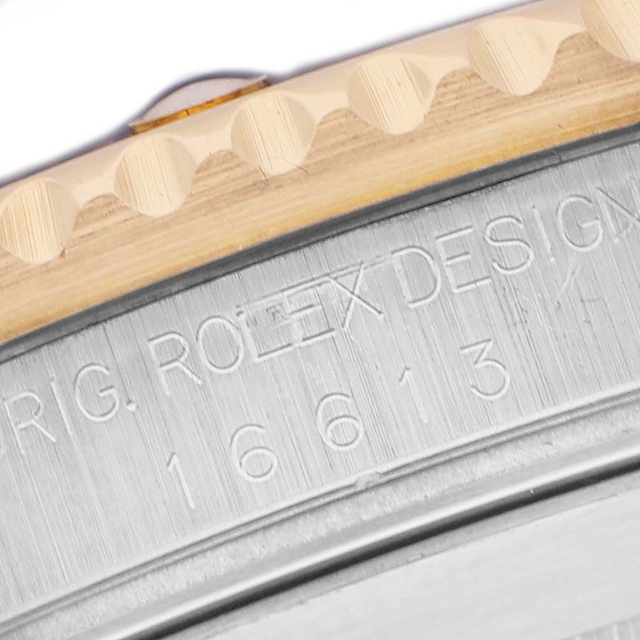 The image shows a close-up of the Rolex Submariner 16613LB Men's Stainless Steel Blue Dial's bezel edge and engraved model number on the case.