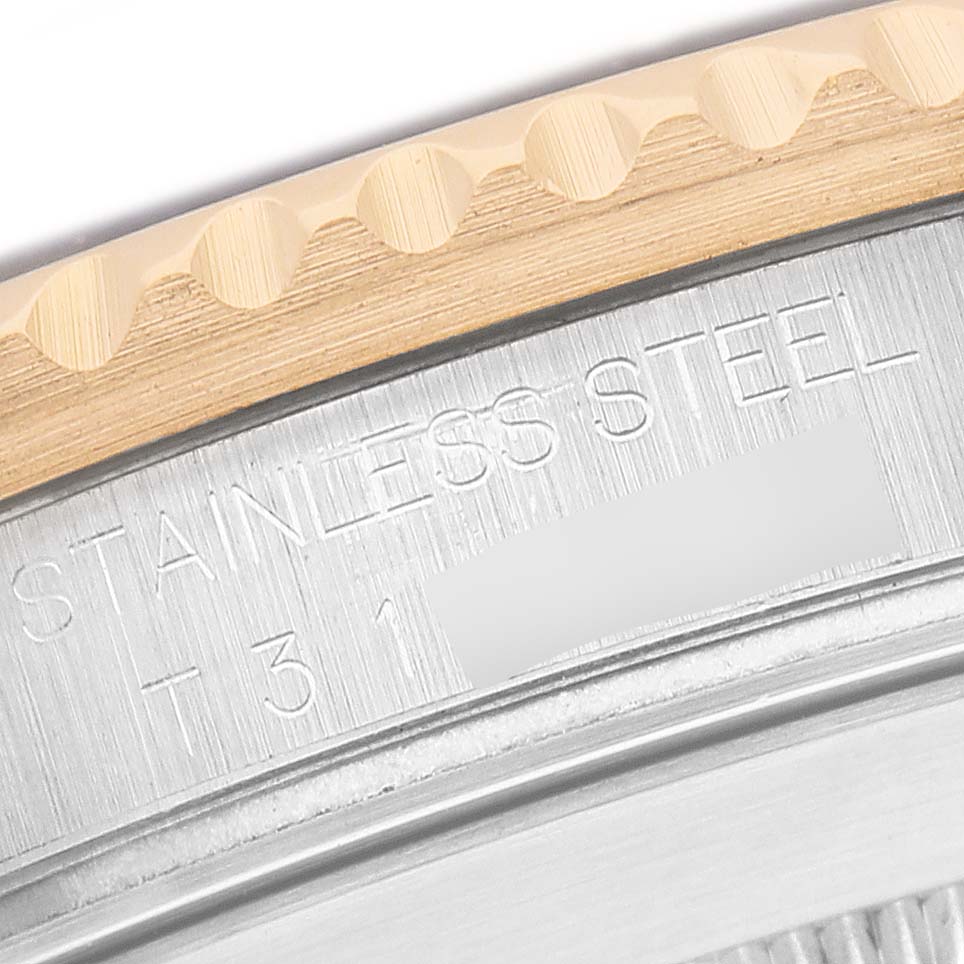 The image shows a close-up of the edge and bezel area of a Rolex Submariner 16613LB Men's Stainless Steel Blue Dial, highlighting the stainless steel and engraving details.