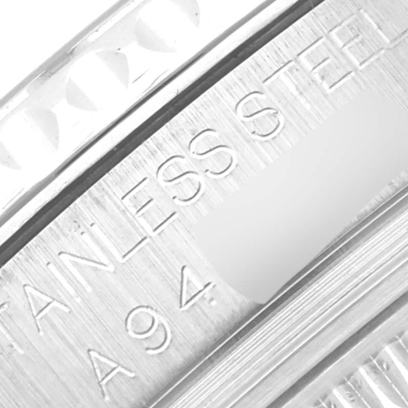 This close-up image of a Rolex Yacht-Master 168622 Men's Stainless Steel Grey Dial 168622 Men's Stainless Steel Grey Dial watch shows part of the bezel and engraved text on the stainless steel case.