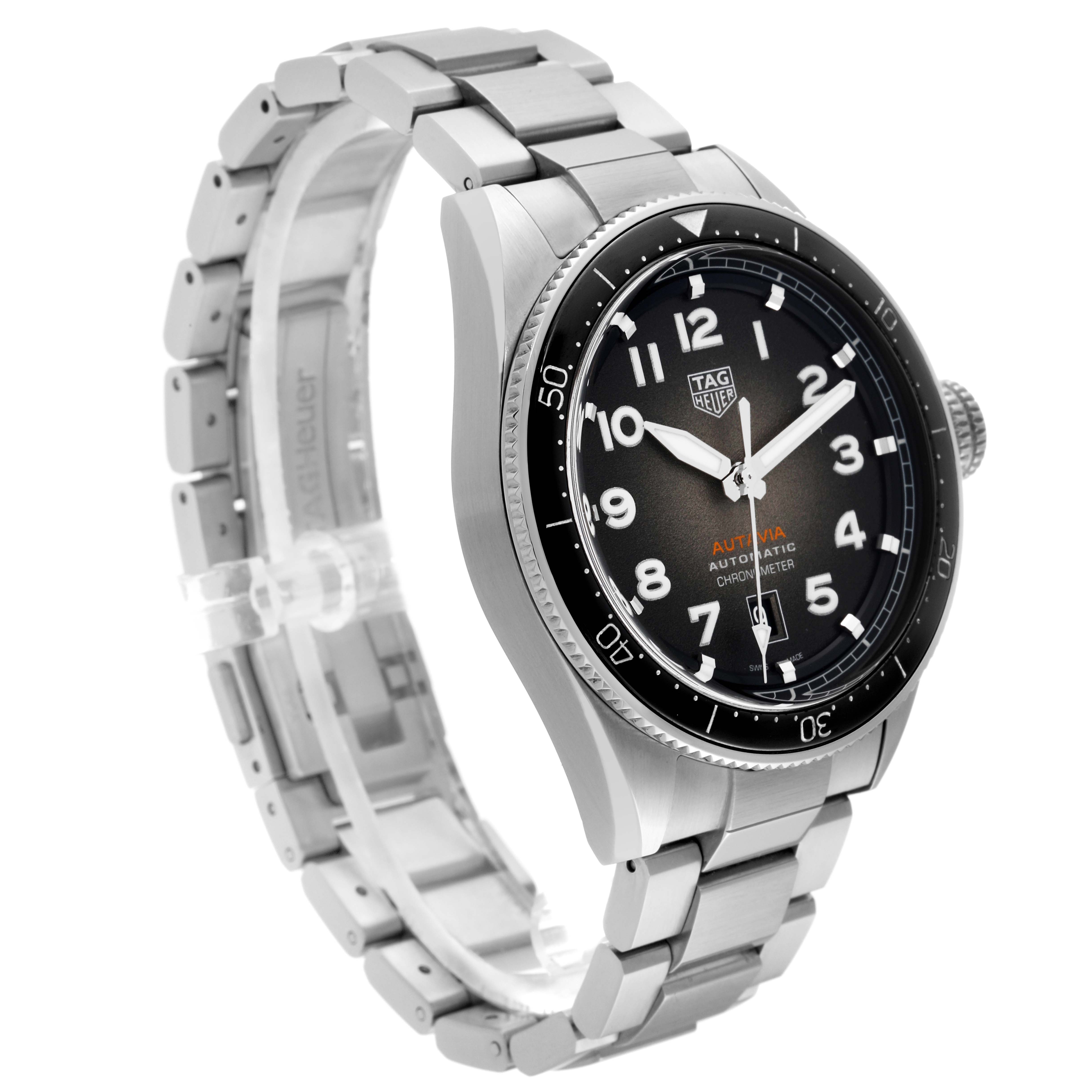 The image shows a Tag Heuer Autavia 63464 Men's Stainless Steel Brown Dial 63464 Men's Stainless Steel Brown Dial watch at a three-quarter angle, highlighting its black dial, bezel, and metal bracelet.
