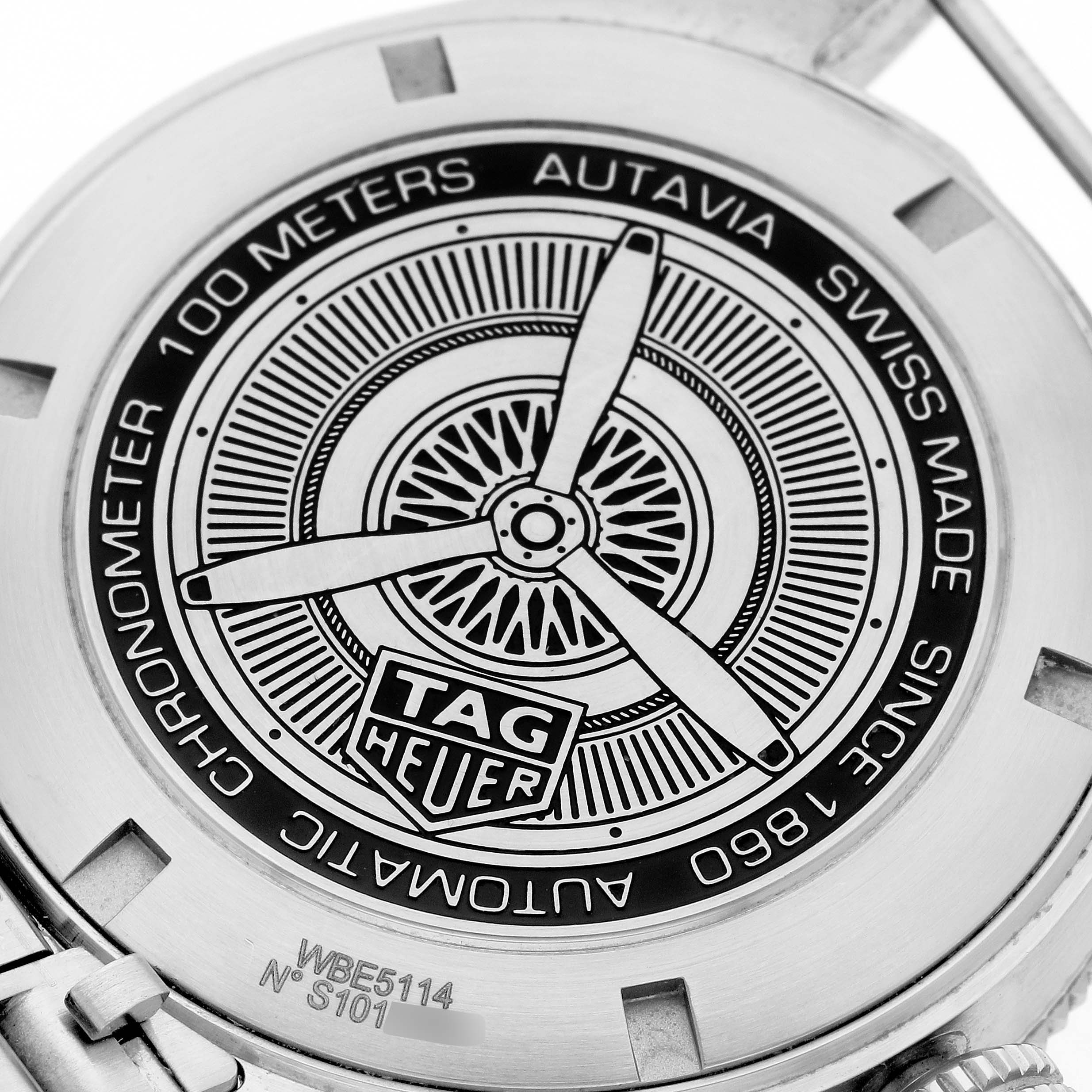 The image shows the engraved case back of the Tag Heuer Autavia 63464 Men's Stainless Steel Brown Dial 63464 Men's Stainless Steel Brown Dial model watch.