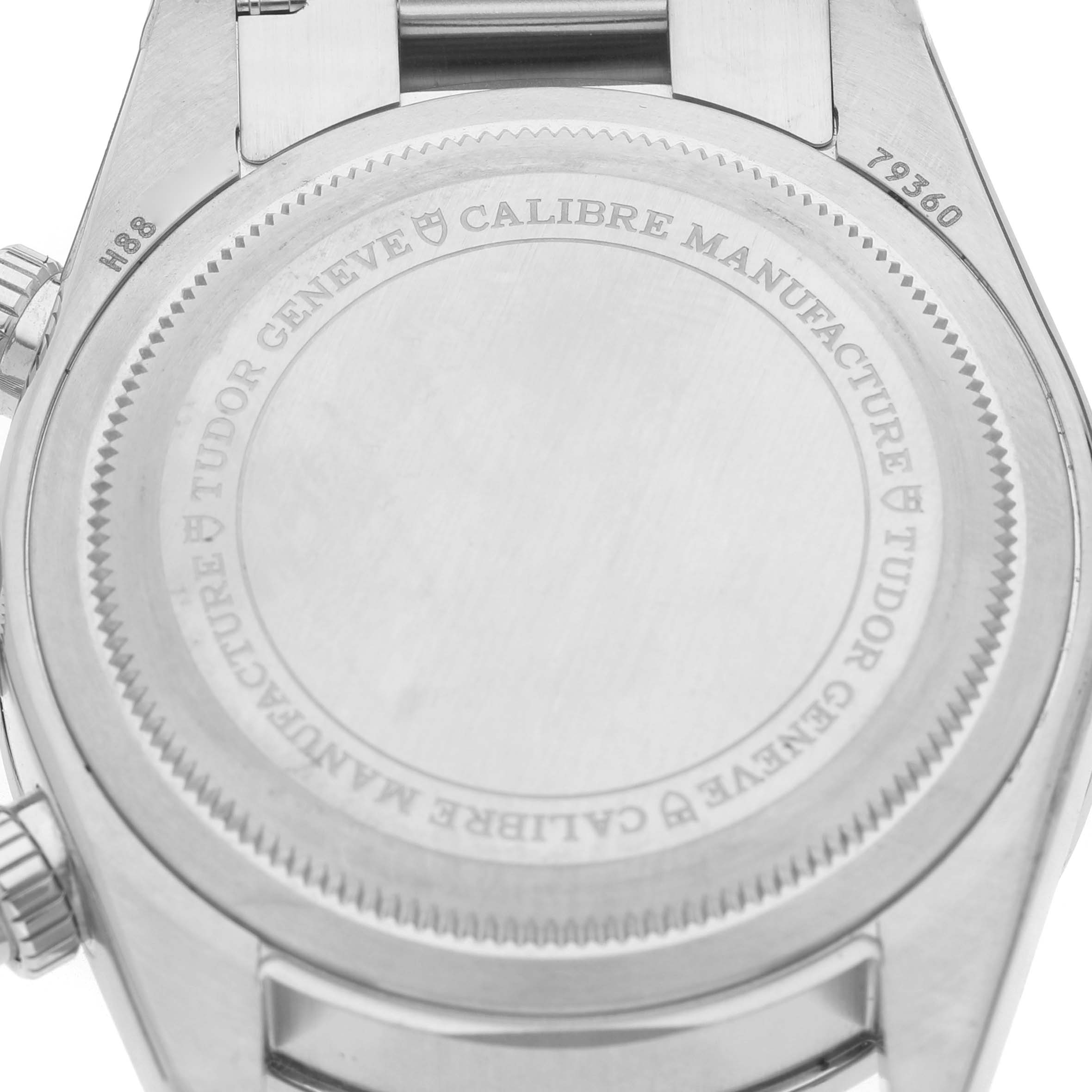 The image shows the case back of a Tudor Heritage Black Bay M79360N-002 Men's Stainless Steel Silver Dial watch at a close-up angle, highlighting the engraved details.
