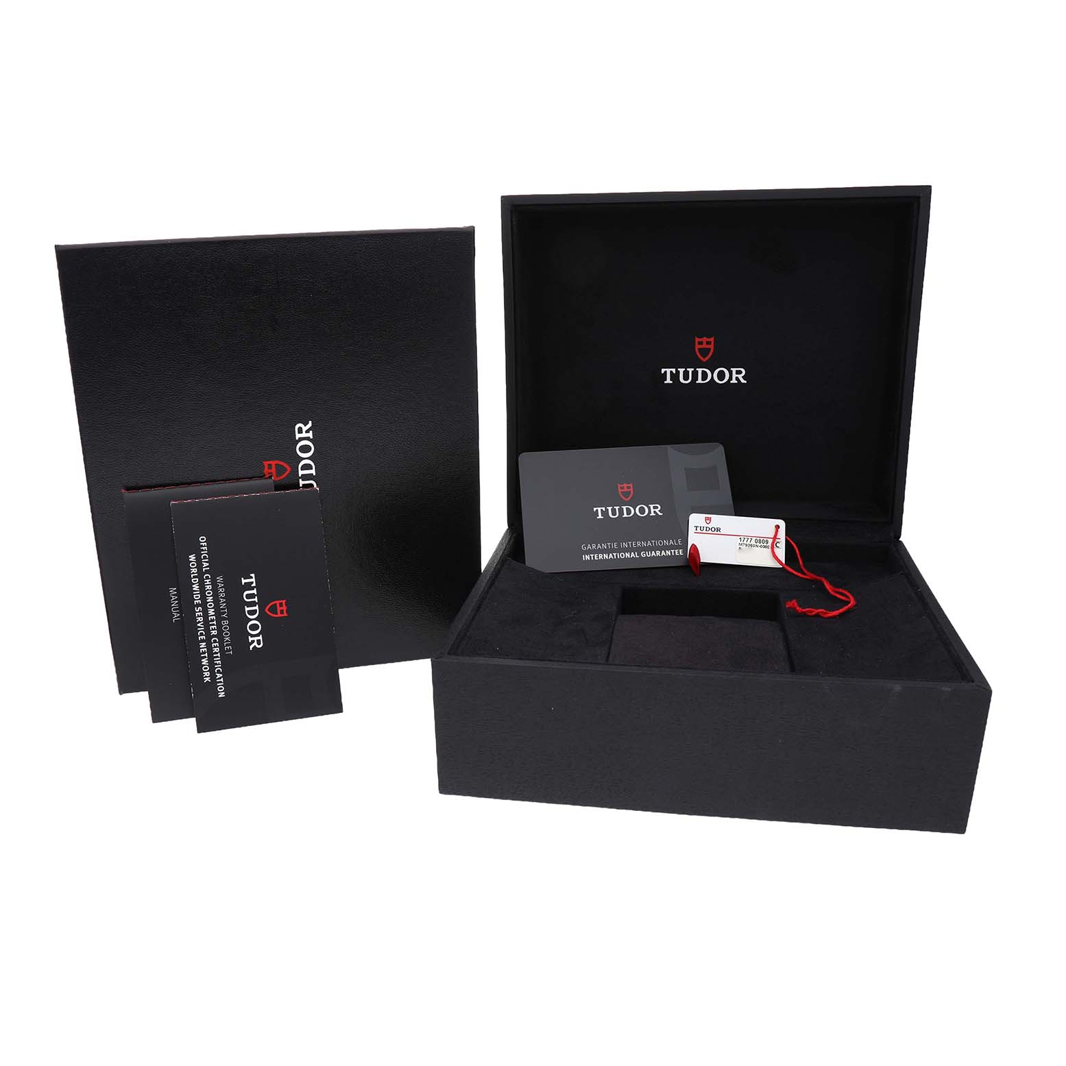 The image shows the open packaging of a Tudor Heritage Black Bay M79360N-002 Men's Stainless Steel Silver Dial watch, including the box, tags, and guarantee card.