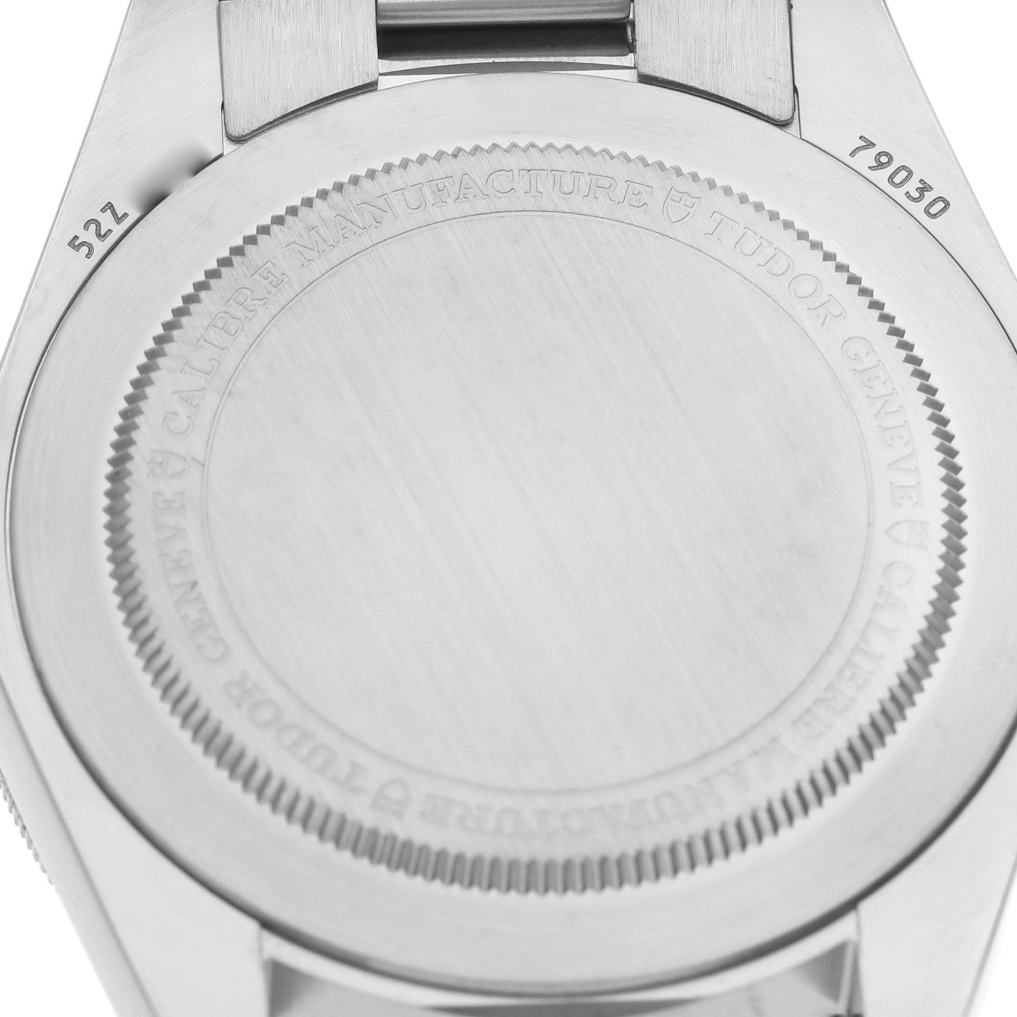 The image shows the case back of a Tudor Heritage Black Bay M79030N-0001 Men's Stainless Steel Black Dial watch with inscriptions around its edge.