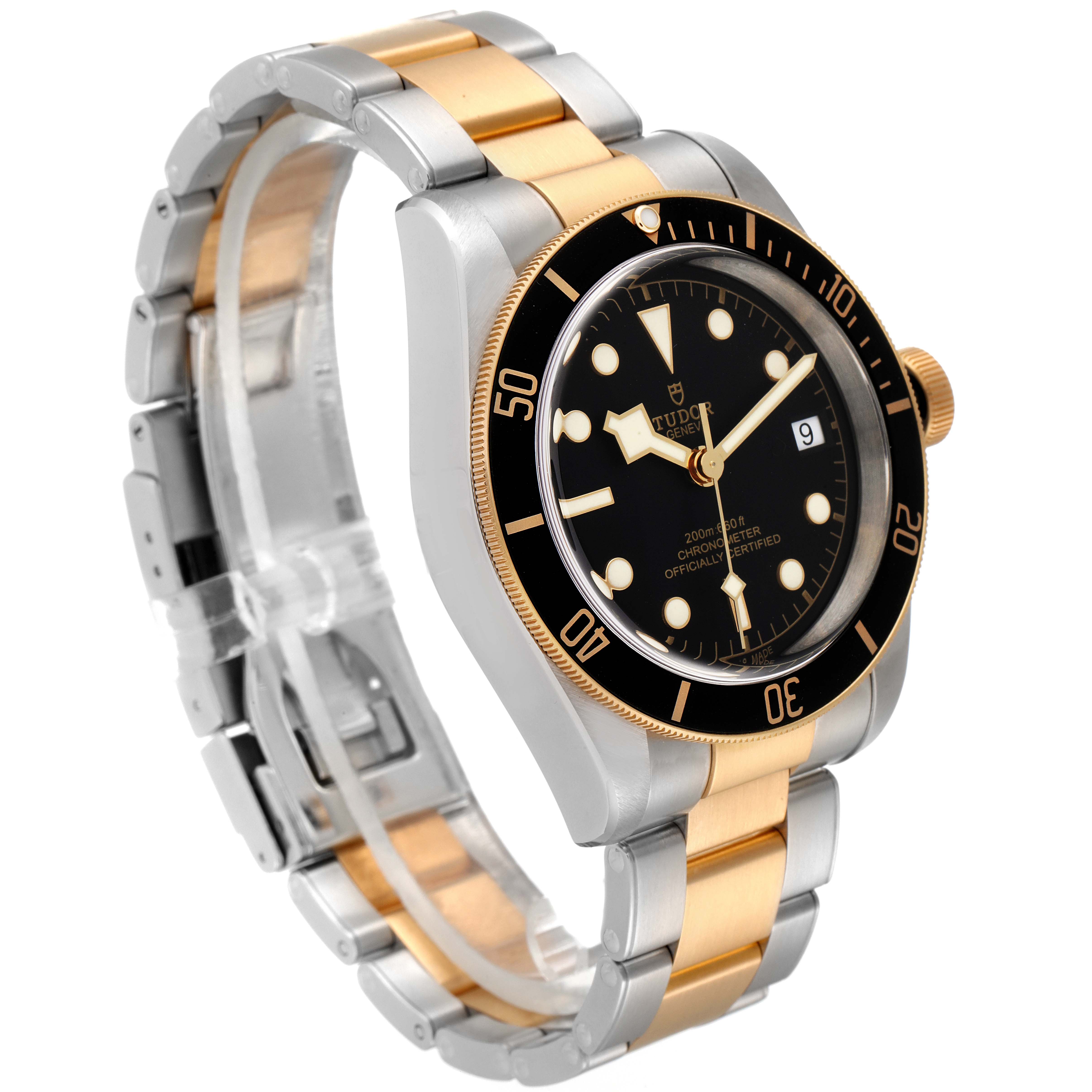 The image shows a Heritage Black Bay model by Tudor at an angle highlighting the face, bezel, and stainless steel and gold bracelet.