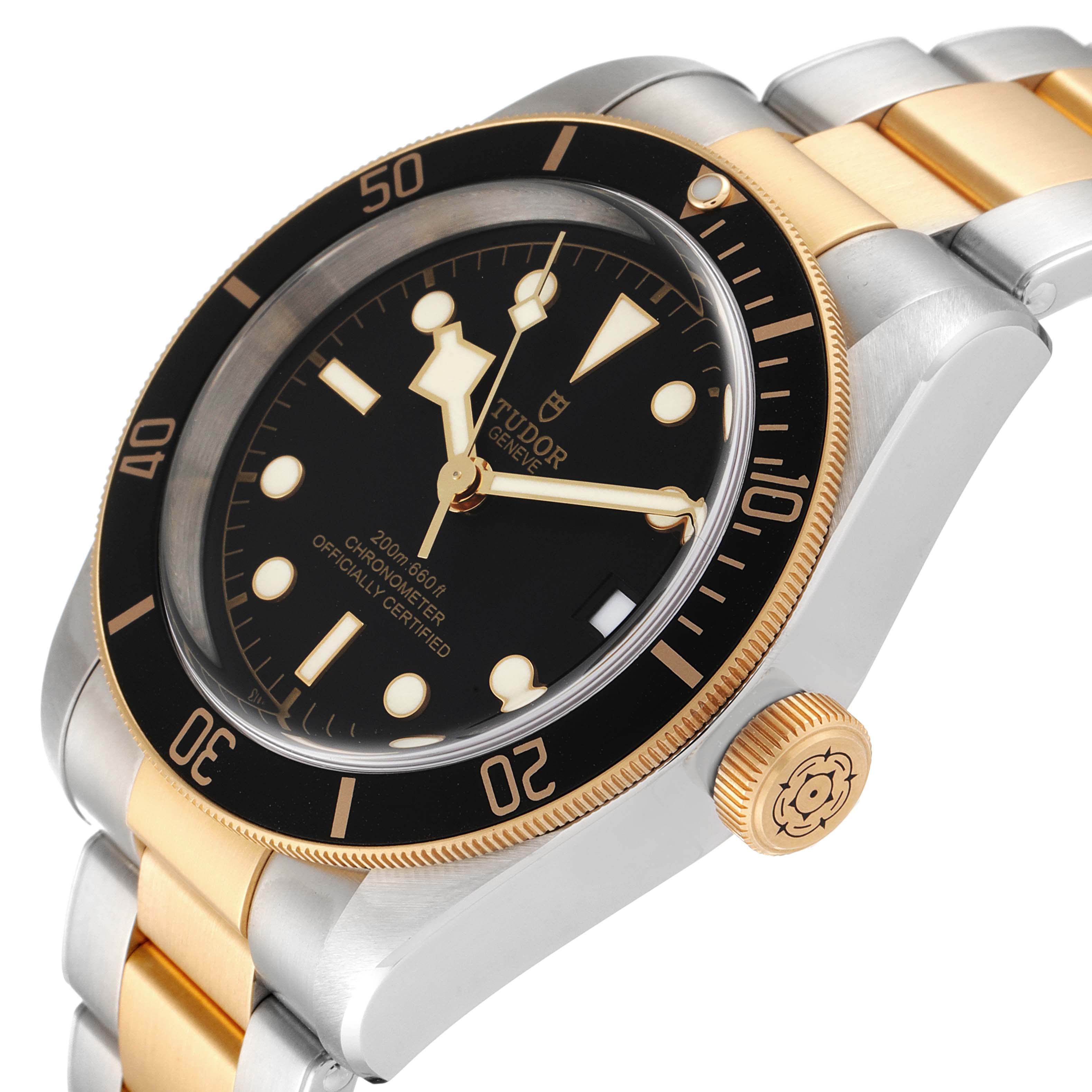 This image shows a Tudor Heritage Black Bay 79733 Men
s Steel and Gold (two tone) Black Dial 79733 Men
s Steel and Gold (two tone) Black Dial watch at an angled close-up, highlighting its bezel, dial, crown, and bracelet.