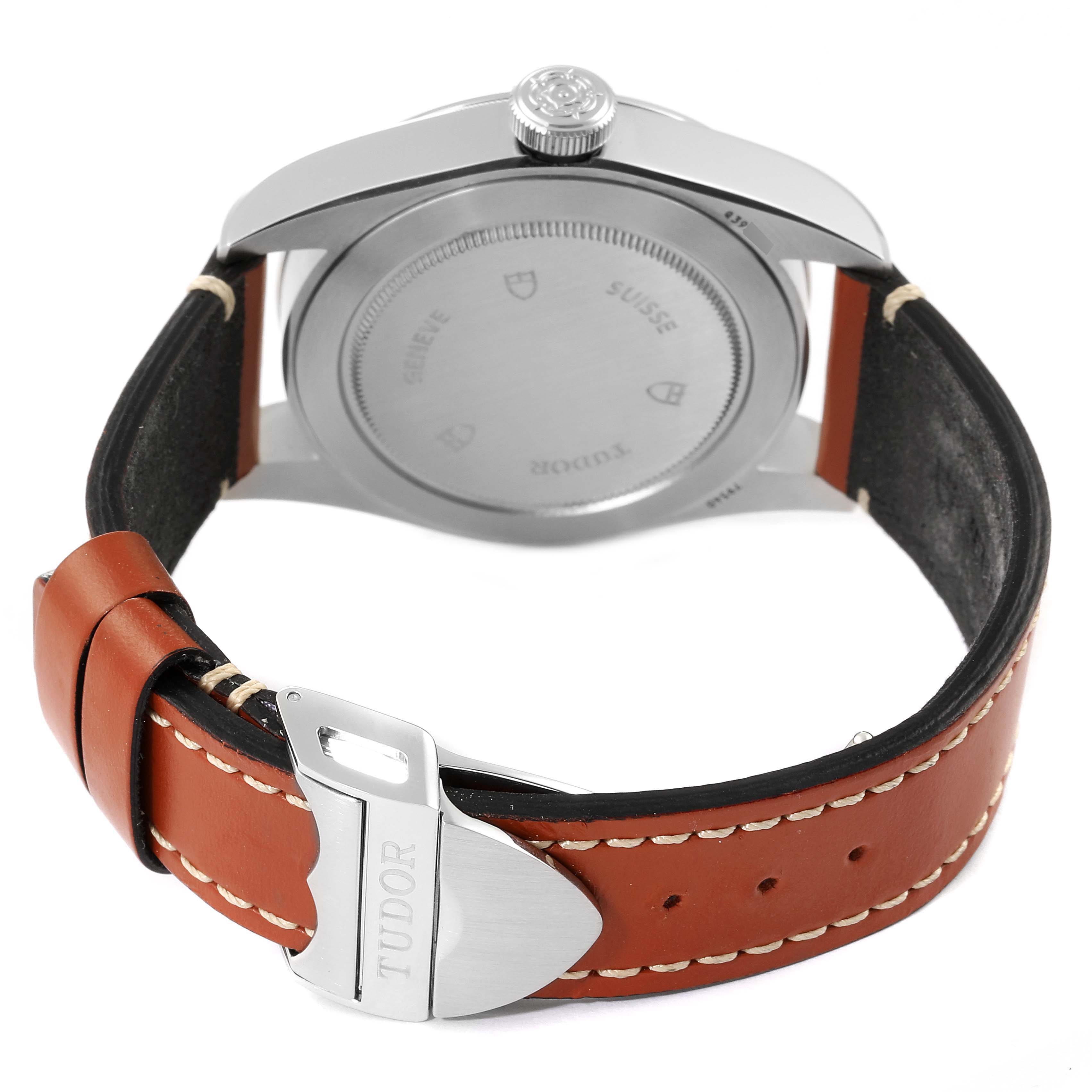 The image shows the back view of a Tudor Heritage Black Bay 79540 Men's Stainless Steel Blue Dial 79540 Men's Stainless Steel Blue Dial watch with its case back, crown, and brown leather strap.