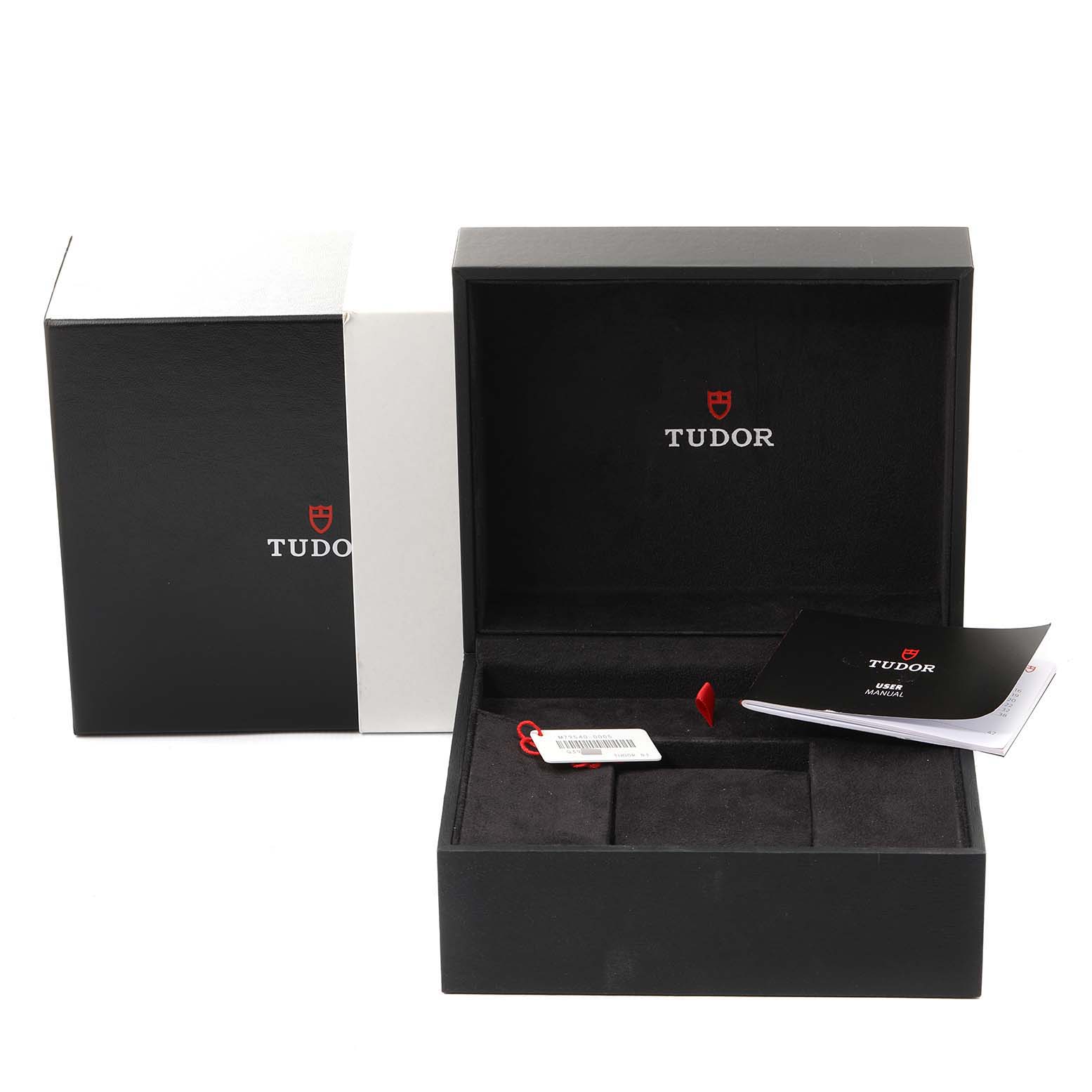 The image shows the open box of a Tudor Heritage Black Bay 79540 Men's Stainless Steel Blue Dial 79540 Men's Stainless Steel Blue Dial watch, along with its manual and hangtag.