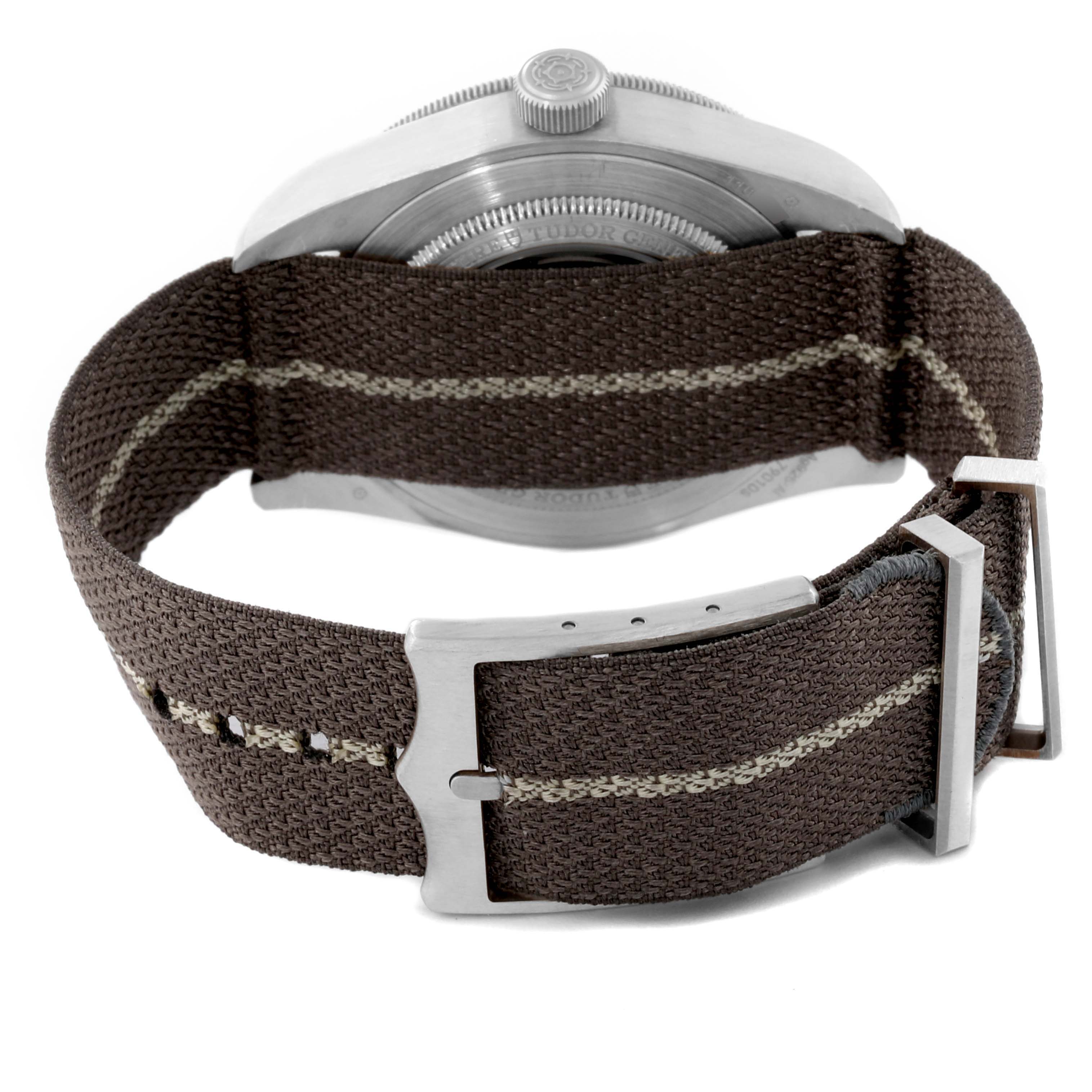 The image shows the back view of a Tudor Heritage Black Bay M79010SG-0002 Men's Stainless Steel Grey Dial M79010SG-0002 Men's Stainless Steel Grey Dial watch, featuring its case and fabric strap with the buckle.