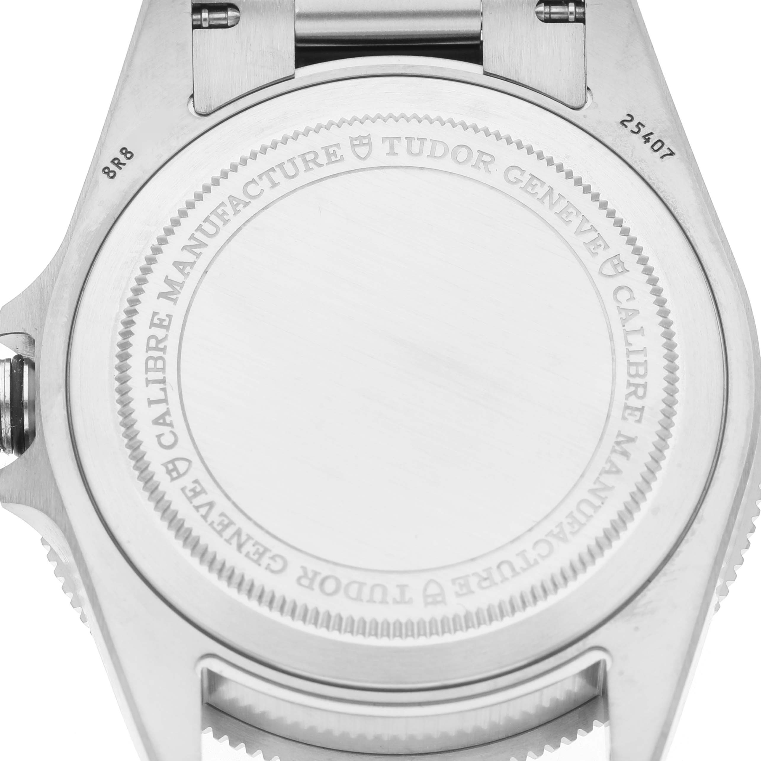 The image shows the back case of a Tudor Pelagos M25407N Men's Titanium Black Dial watch, highlighting engravings around the edge.
