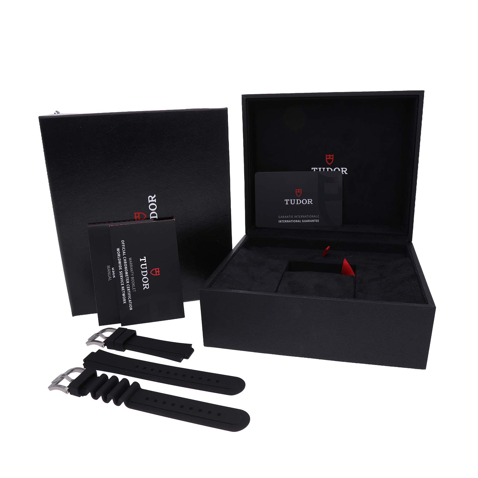 The Tudor Pelagos M25407N Men's Titanium Black Dial watch accessories are shown, including a box, straps, and manuals, viewed from the top angle.