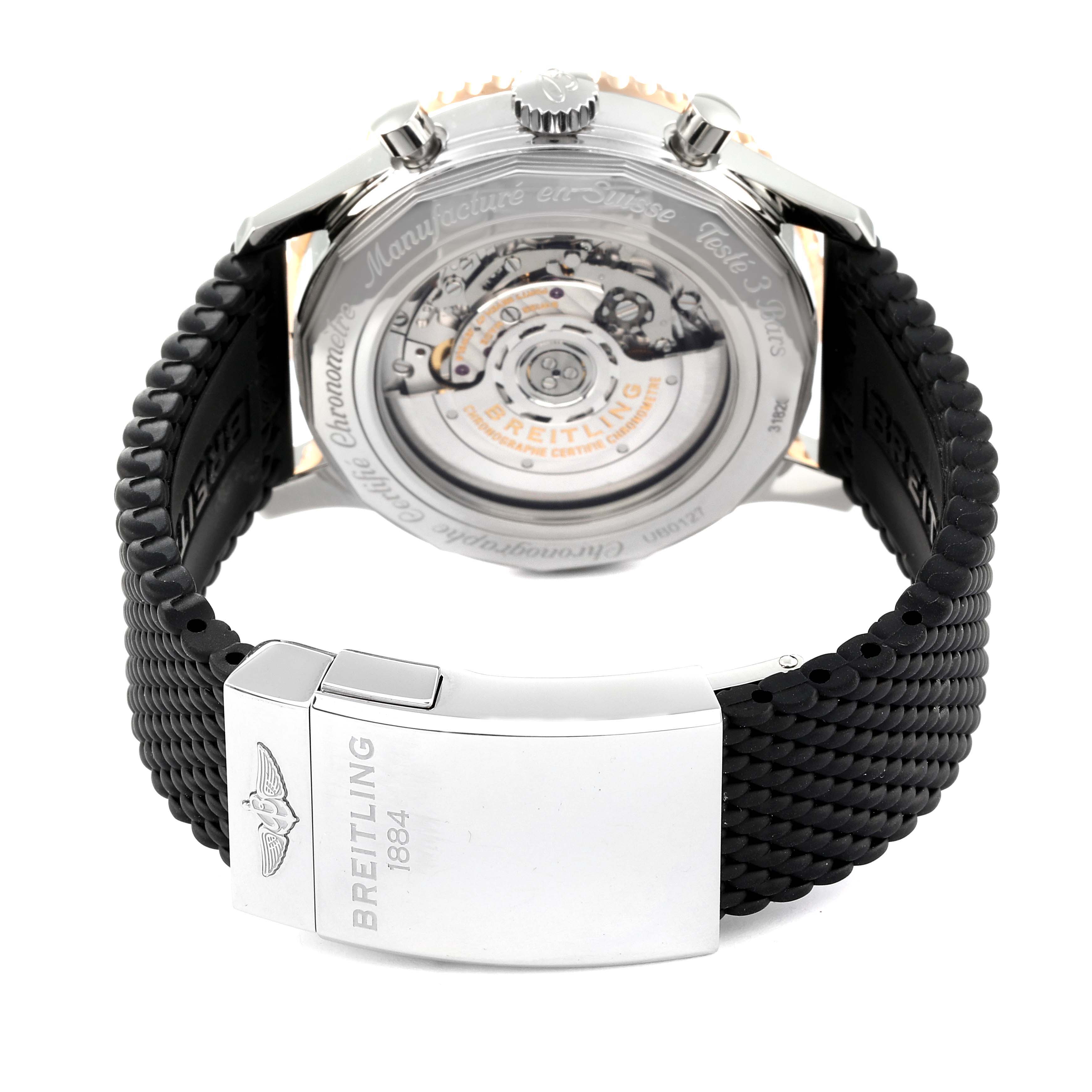 This image shows the back view of a Breitling Navitimer UB0127 Men
s Steel and Gold (two tone) Black Dial UB0127 Men
s Steel and Gold (two tone) Black Dial watch, highlighting its movement and black strap clasp.
