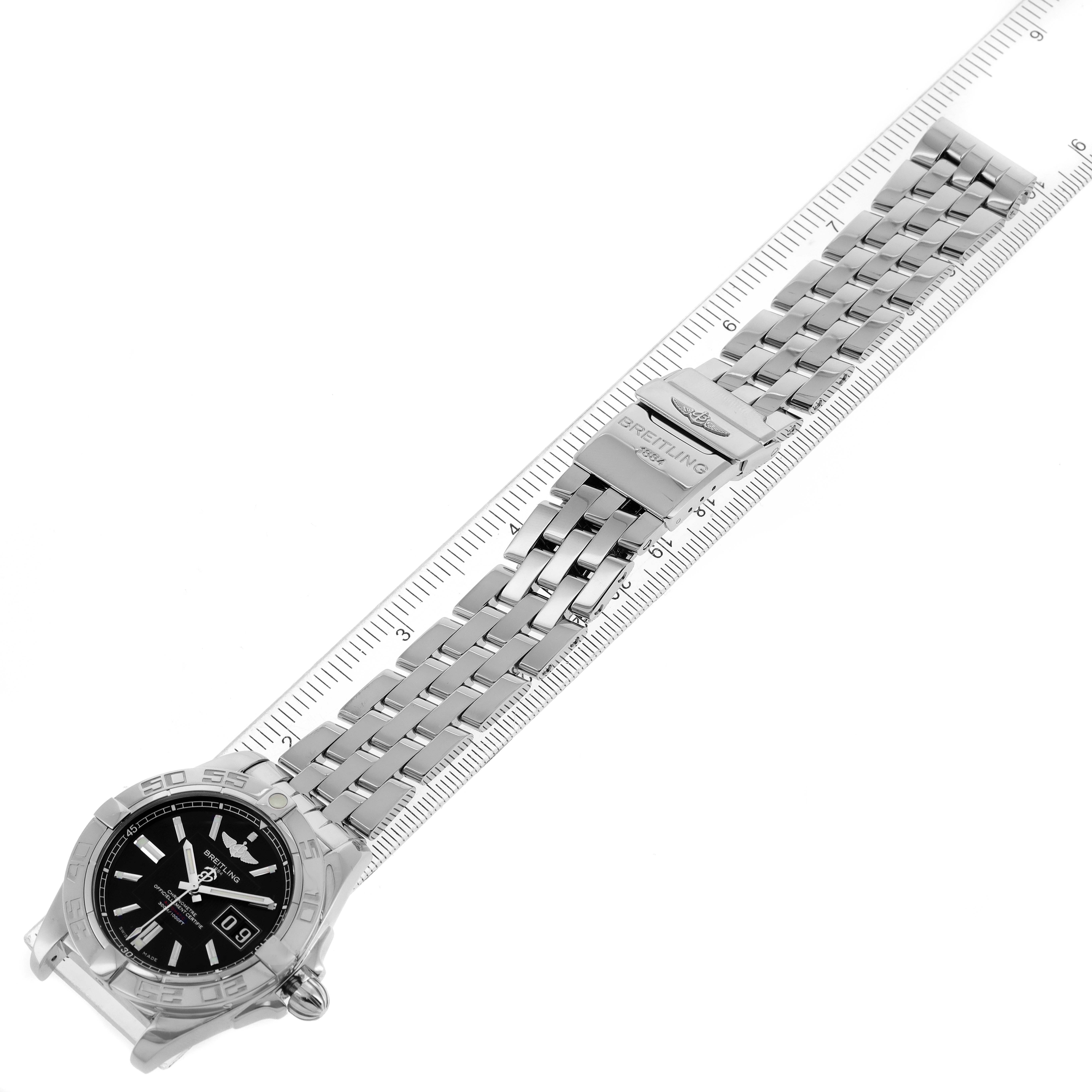 The image shows a Breitling Windrider A49350 Men's Stainless Steel Black Dial A49350 Men's Stainless Steel Black Dial watch laid flat with a ruler, displaying the watch face and metal bracelet.