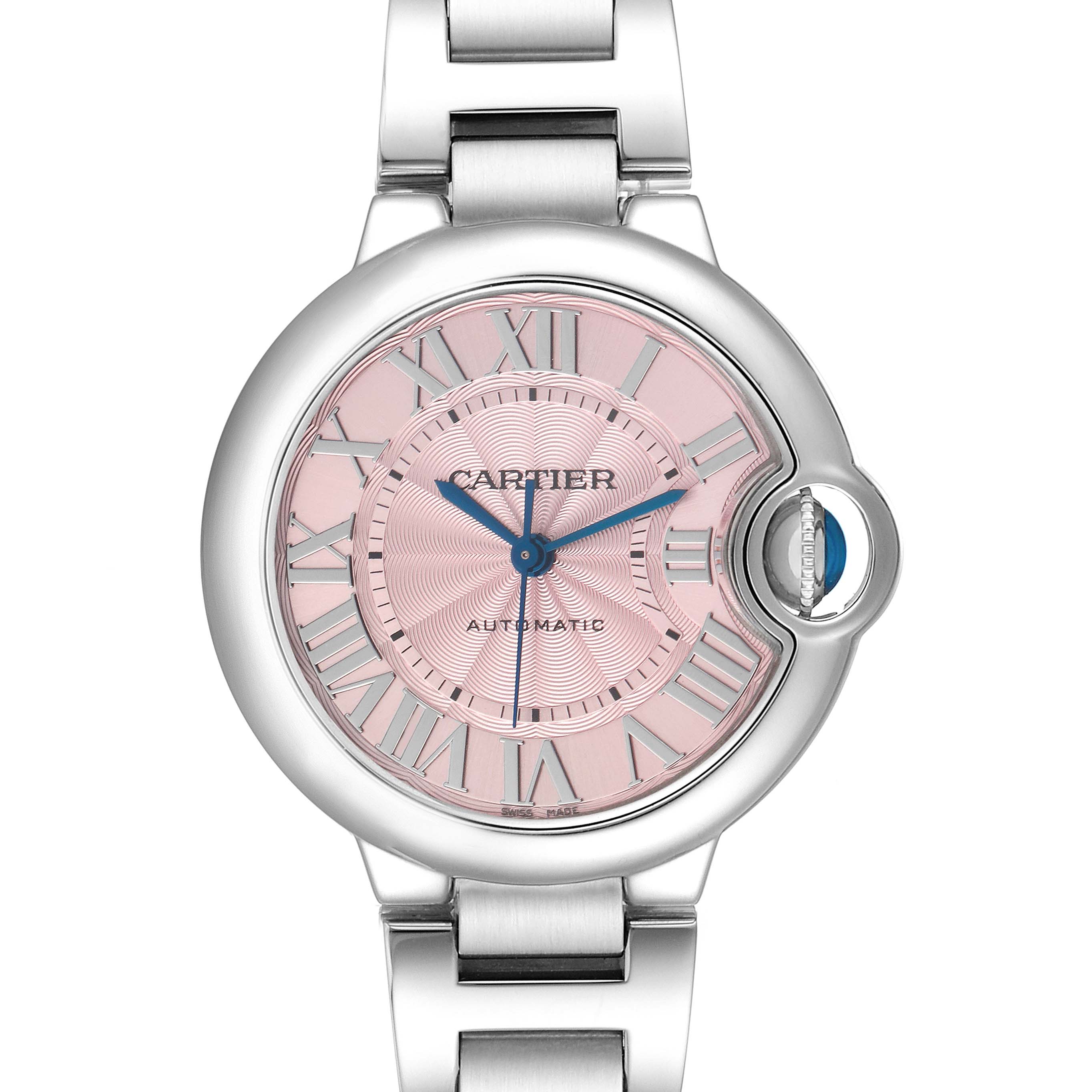 The Ballon Bleu de Cartier watch is shown from a front angle, highlighting its round case, pink dial, blue sword-shaped hands, and metal bracelet.