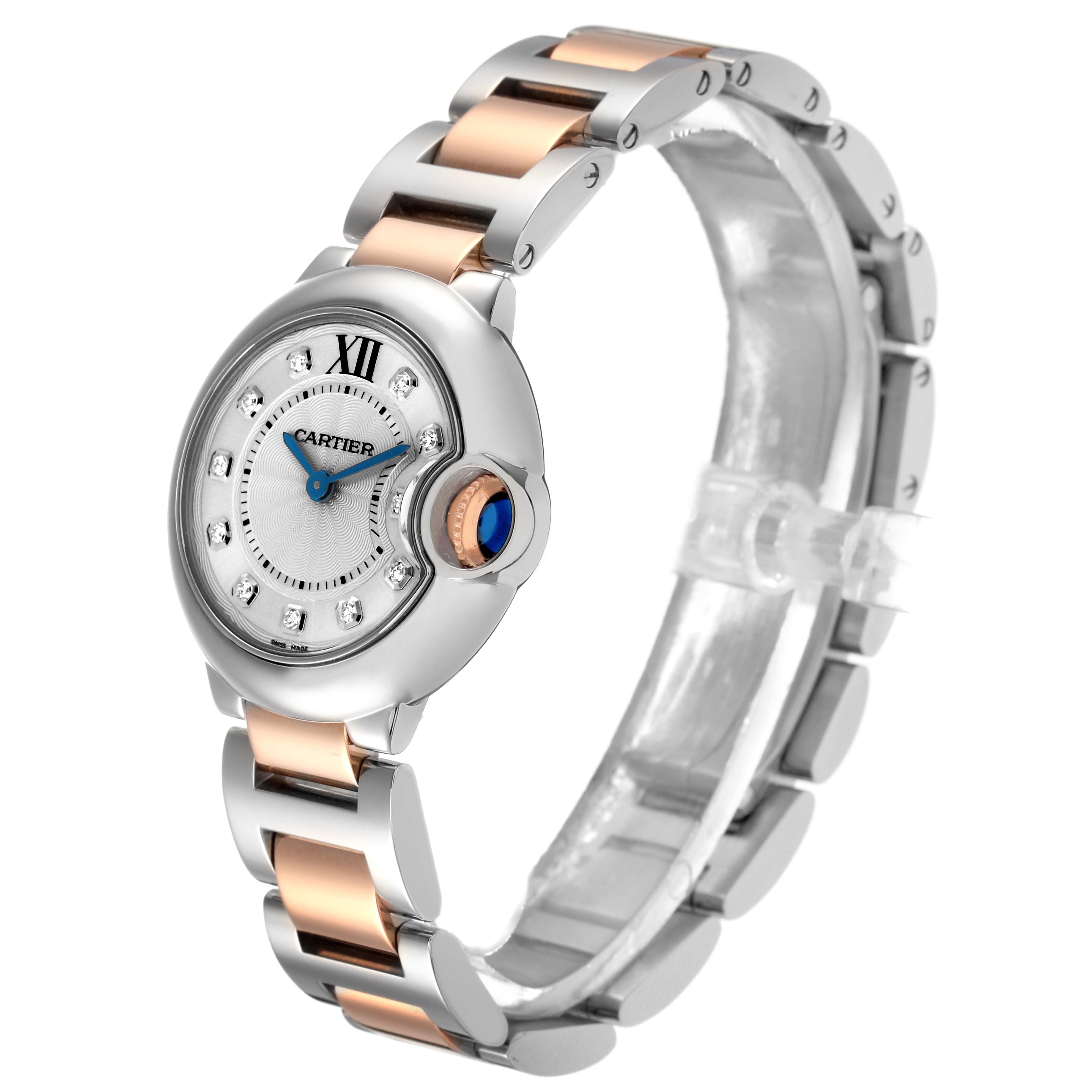 The Cartier Ballon Bleu WE902030 Women
s Steel and Gold (two tone) Silver Dial WE902030 Women
s Steel and Gold (two tone) Silver Dial watch is shown at a side angle, highlighting the dial, bracelet, and crown with a blue gem.