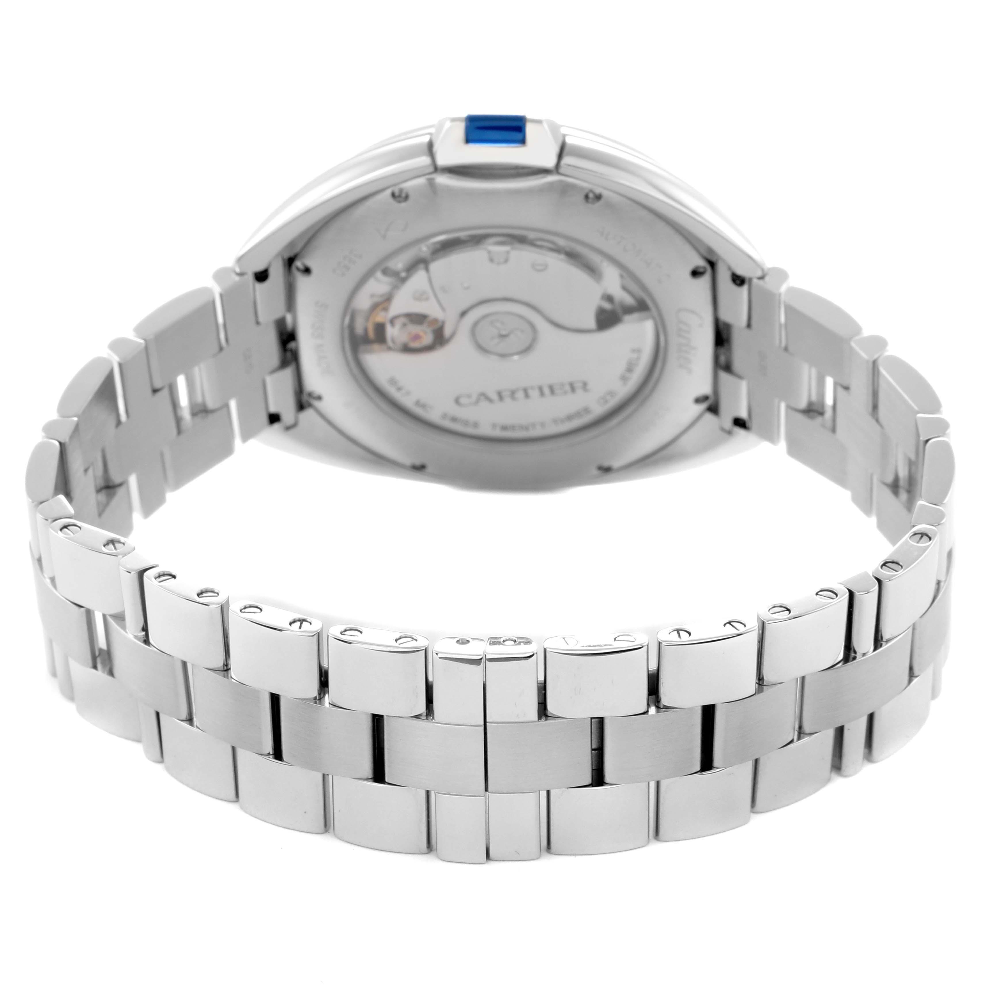 The Cartier Clé watch is shown from the back, highlighting its bracelet and the case back with visible movement.