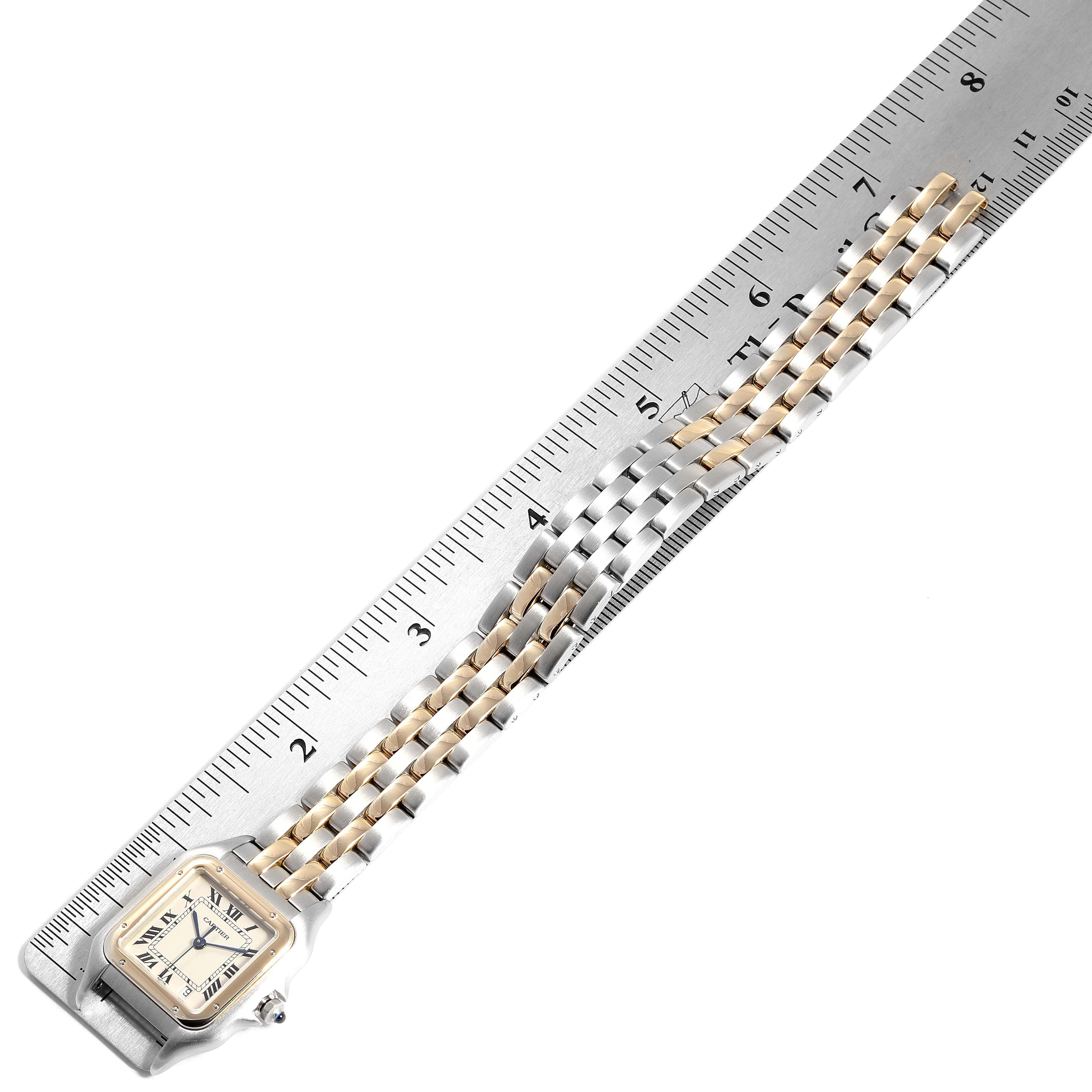 The image shows a Cartier Panthere W25028B8 Men
s Steel and Gold (two tone) Silver Dial W25028B8 Men
s Steel and Gold (two tone) Silver Dial model watch with a clear view of the face, bezel, and bracelet, next to a ruler for scale.