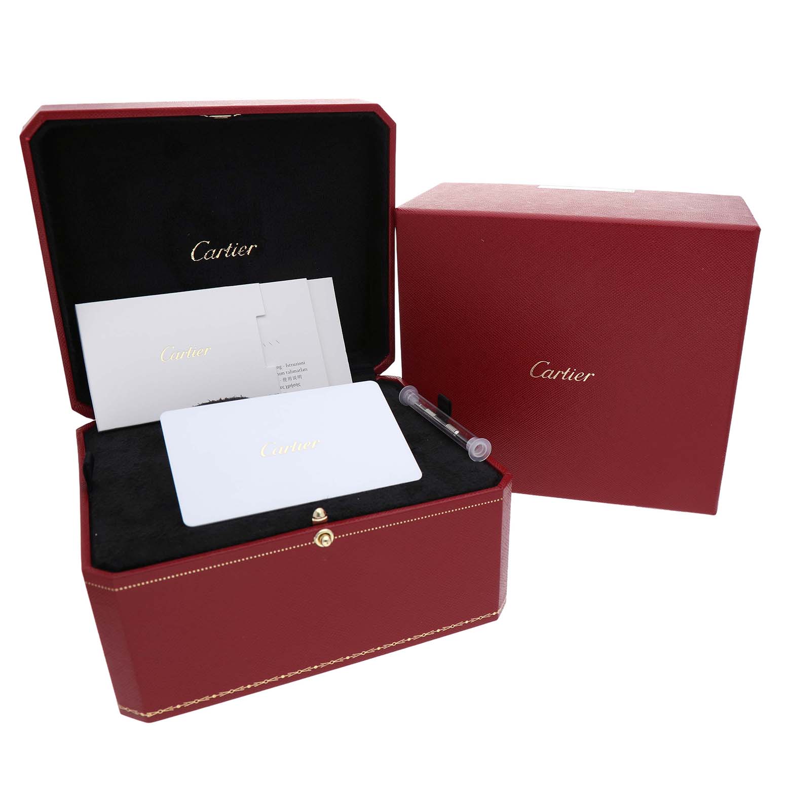 The image shows a Cartier Santos W2SA0016 Men's Stainless Steel Silver Dial watch box and accessories, including paperwork and a tool, at an angle displaying the open box.