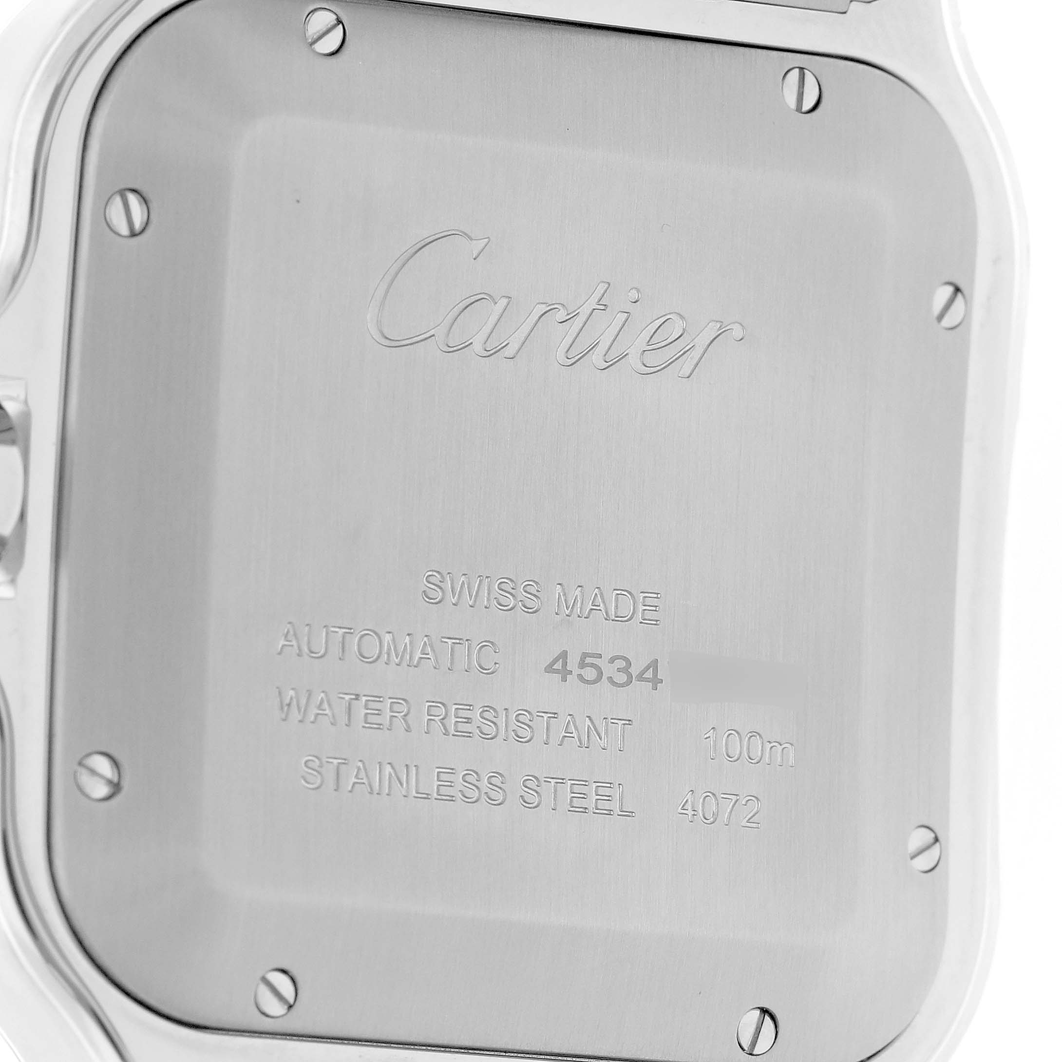 The image shows the back case of a Cartier Santos WSSA0037 Men's Stainless Steel Grey Dial watch, displaying engravings and screws.