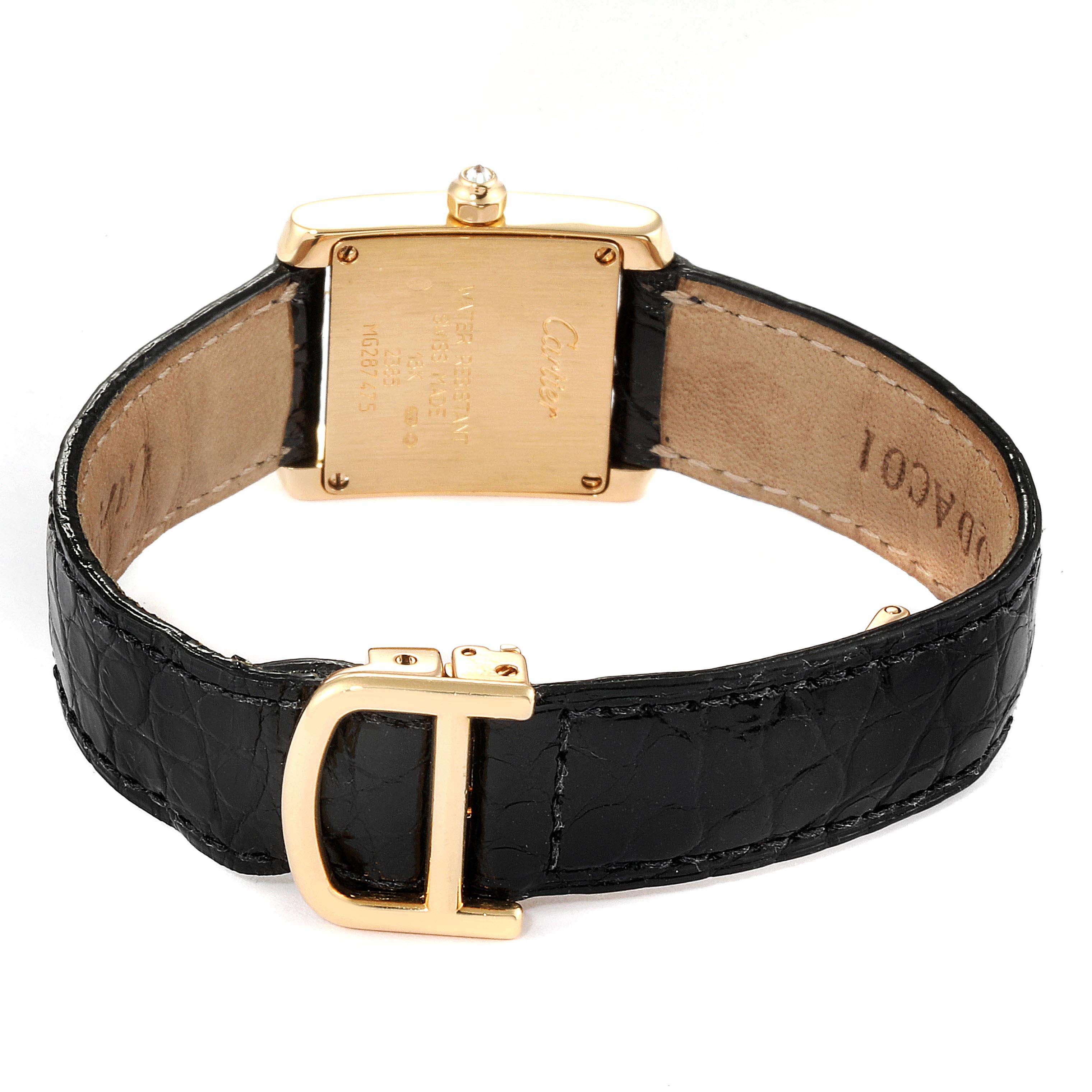 This image shows the back of a Cartier Tank Francaise WE100131 Women's Yellow Gold Silver Dial WE100131 Women's Yellow Gold Silver Dial watch, featuring a gold clasp and a black leather strap.