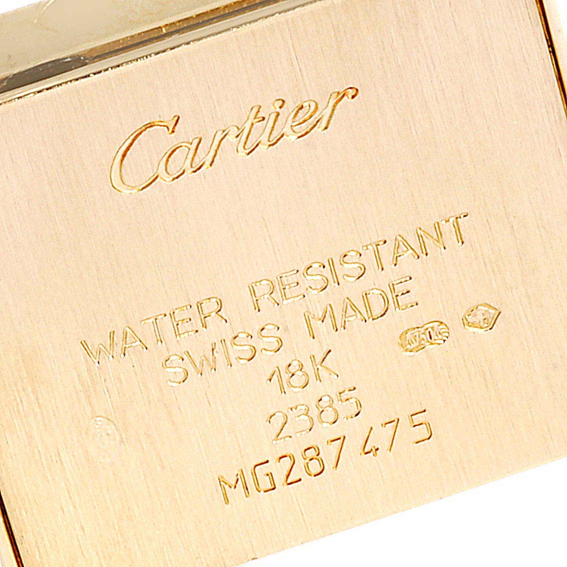 The image shows the back of a Cartier Tank Francaise WE100131 Women's Yellow Gold Silver Dial WE100131 Women's Yellow Gold Silver Dial watch, displaying branding, material, and serial information.