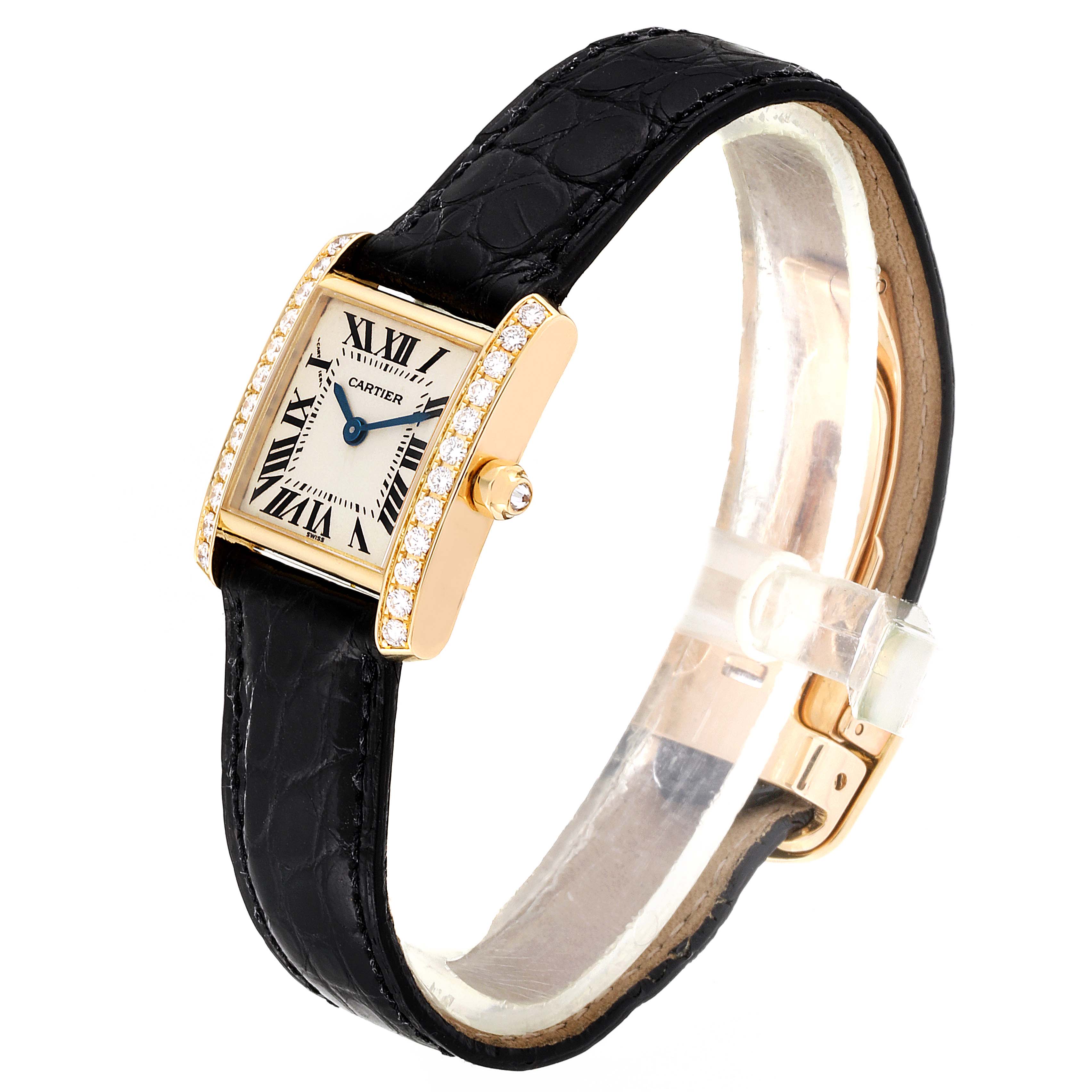 The image shows a Cartier Tank Francaise WE100131 Women's Yellow Gold Silver Dial WE100131 Women's Yellow Gold Silver Dial watch from a three-quarter angle, highlighting its face, diamond bezel, and black leather strap.