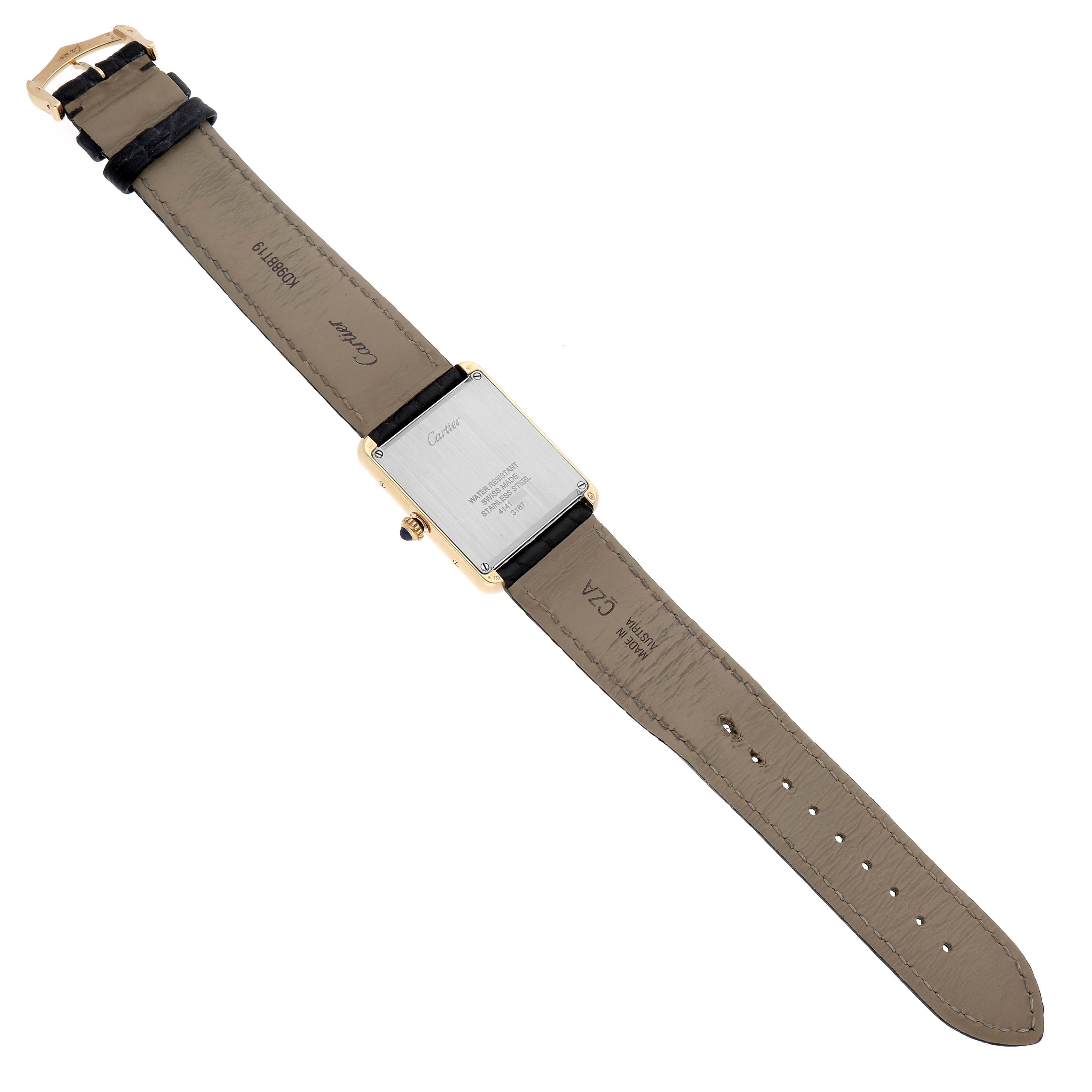 The image displays the backside of a Cartier Tank Solo W5200004 Men's Yellow Gold Silver Dial W5200004 Men's Yellow Gold Silver Dial watch, showcasing its case back, strap, and buckle from a top-down angle.