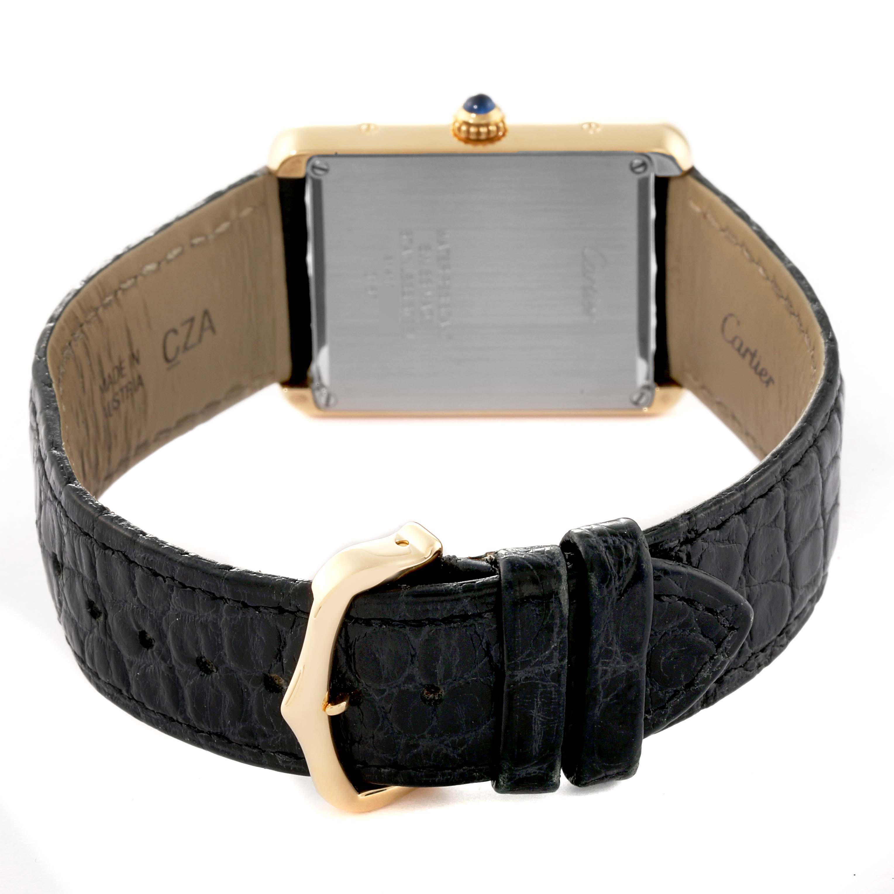 This image shows the back view of a Cartier Tank Solo W5200004 Men's Yellow Gold Silver Dial W5200004 Men's Yellow Gold Silver Dial watch along with the leather strap and buckle.