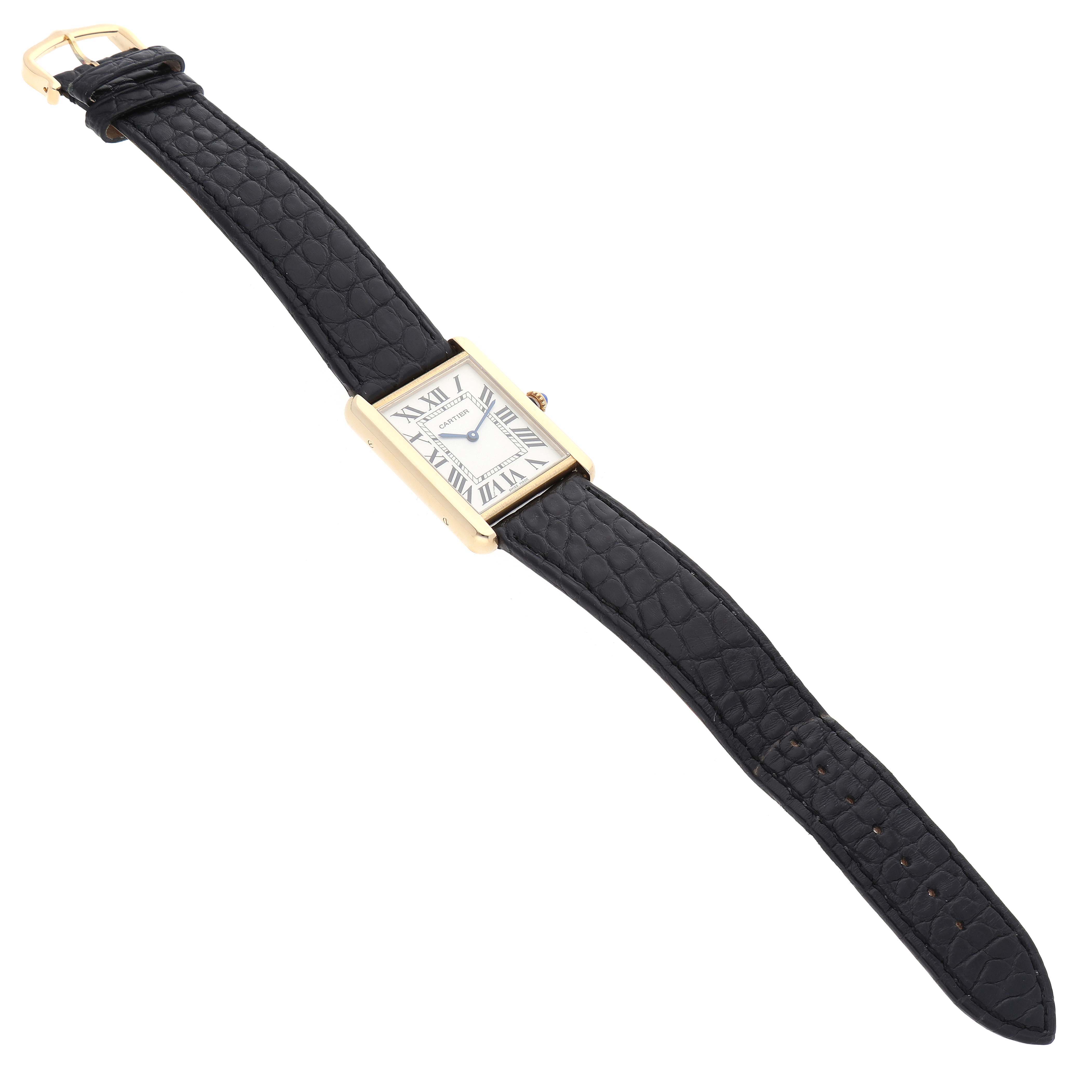 This image shows the Cartier Tank Solo 62230 Men
s Yellow Gold Silver Dial 62230 Men
s Yellow Gold Silver Dial watch from a top-down angle, displaying its face, case, and leather strap.