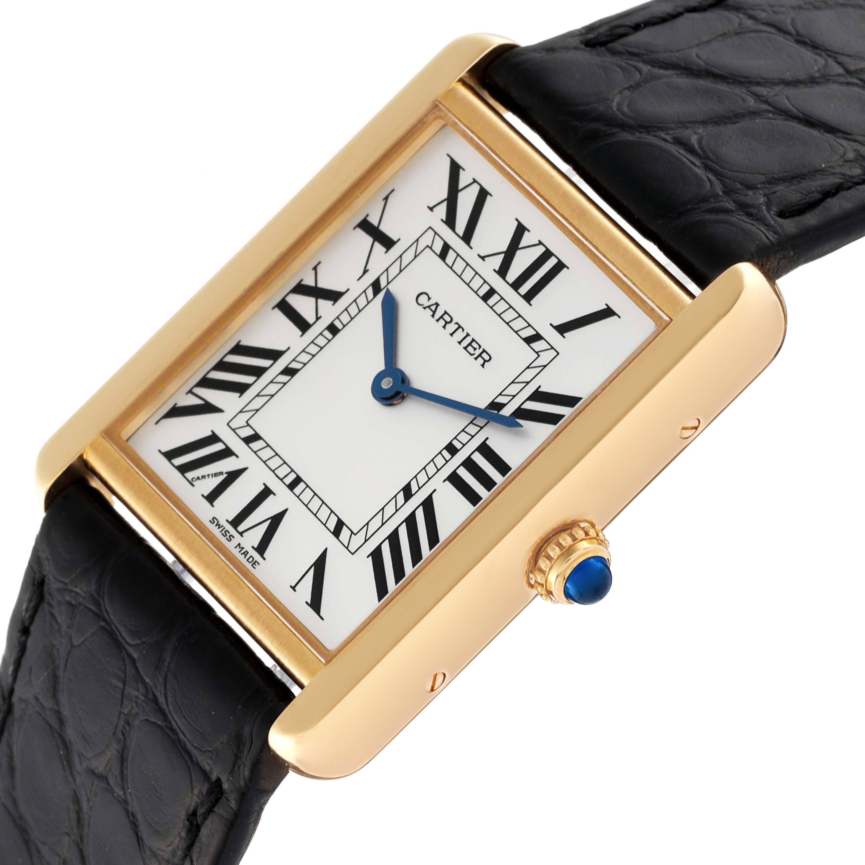 The Cartier Tank Solo W5200004 Men
s Yellow Gold Silver Dial W5200004 Men
s Yellow Gold Silver Dial watch is shown at an angle highlighting its rectangular face, gold casing, Roman numerals, and black strap.