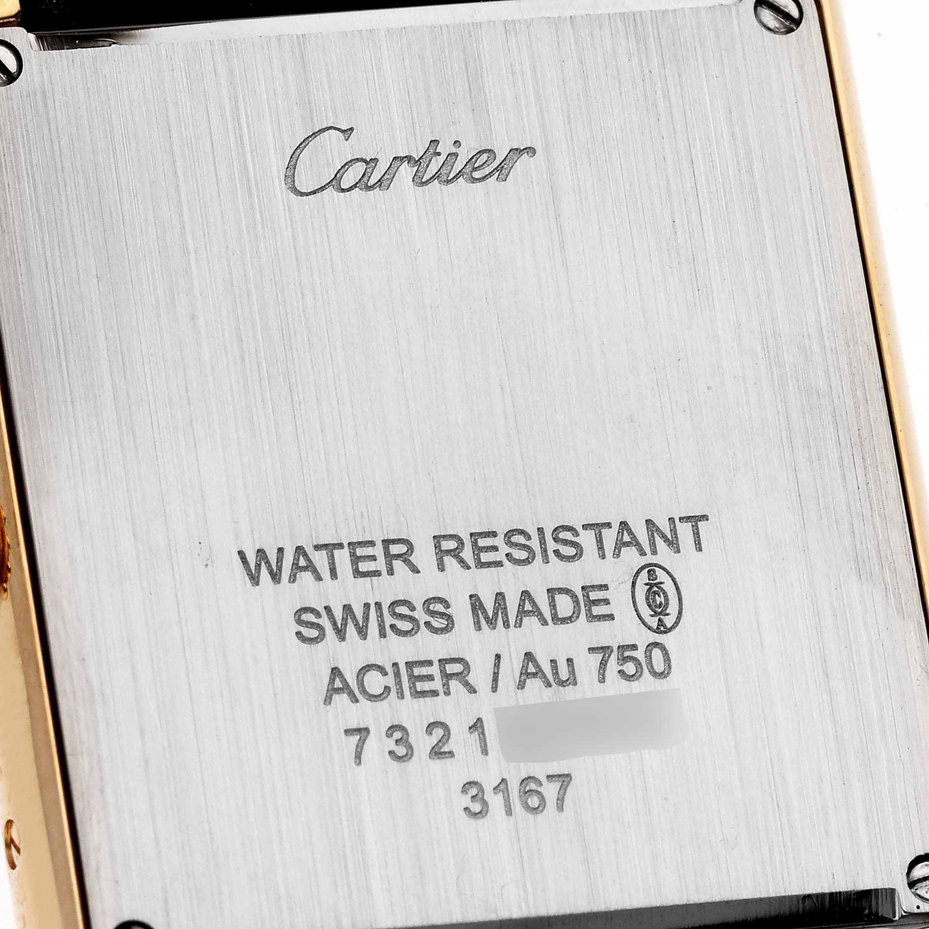 The image shows the back of a Cartier Tank Solo W5200004 Men
s Yellow Gold Silver Dial W5200004 Men
s Yellow Gold Silver Dial watch, displaying its brand engraving and material details.