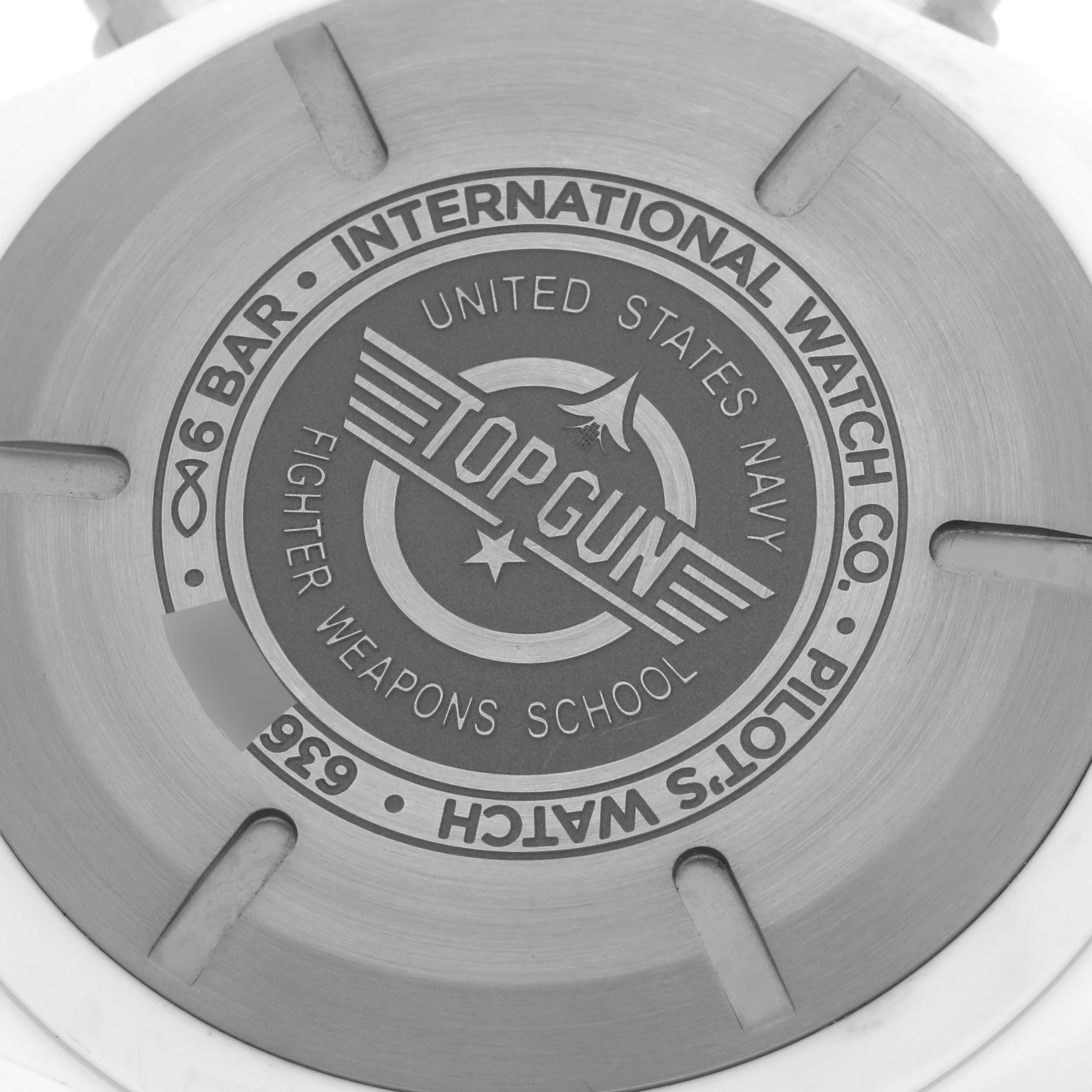 This image shows the closed case back of the IWC Pilot IW389105 Men's Ceramic Grey Dial IW389105 Men's Ceramic Grey Dial's Watch model, featuring the "Top Gun" engraving.